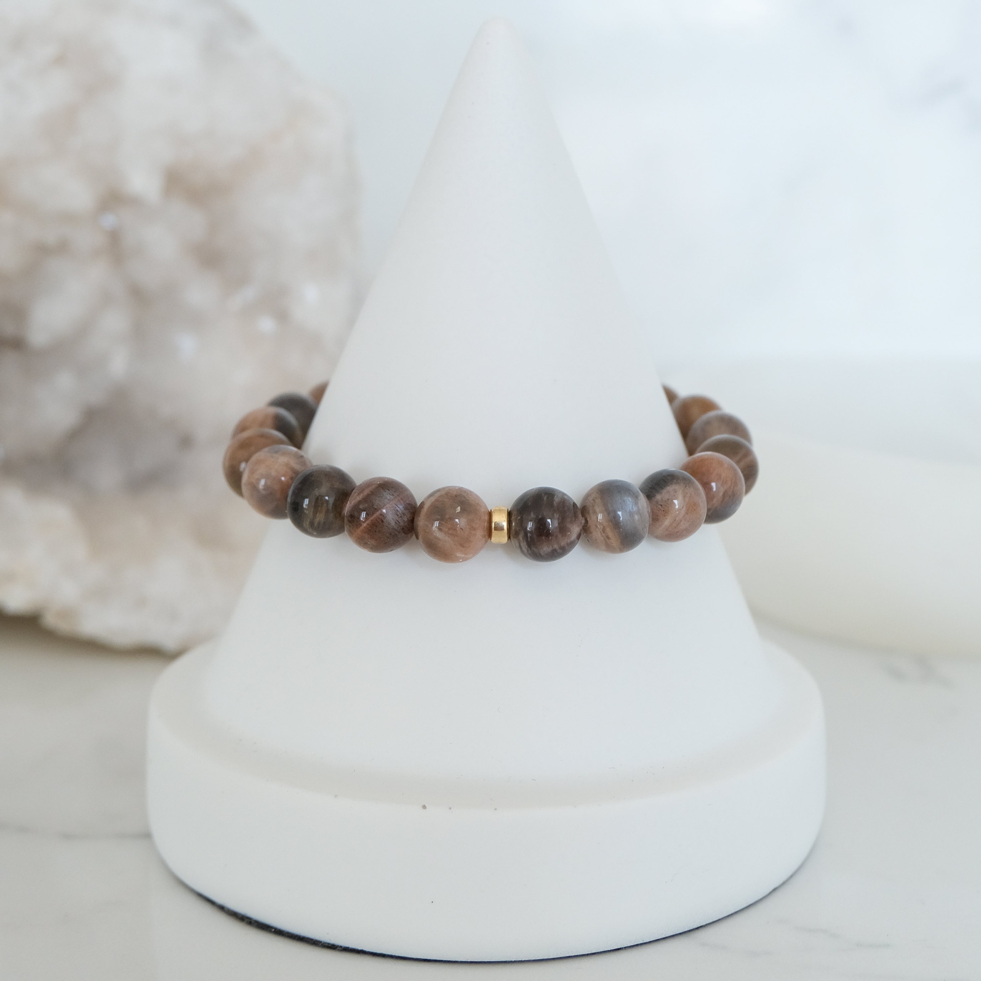 Black moonstone and sunstone gemstone bracelet with gold accessories