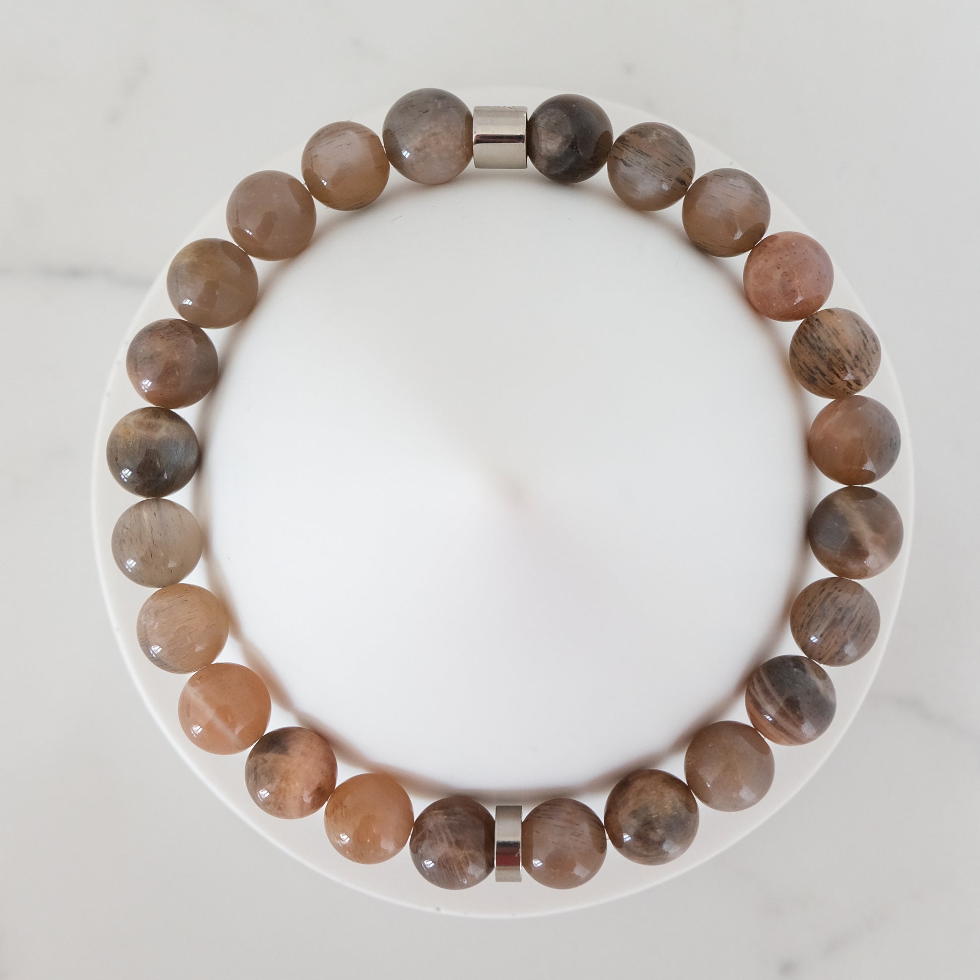 Black moonstone and sunstone gemstone bracelet with steel accessories from above