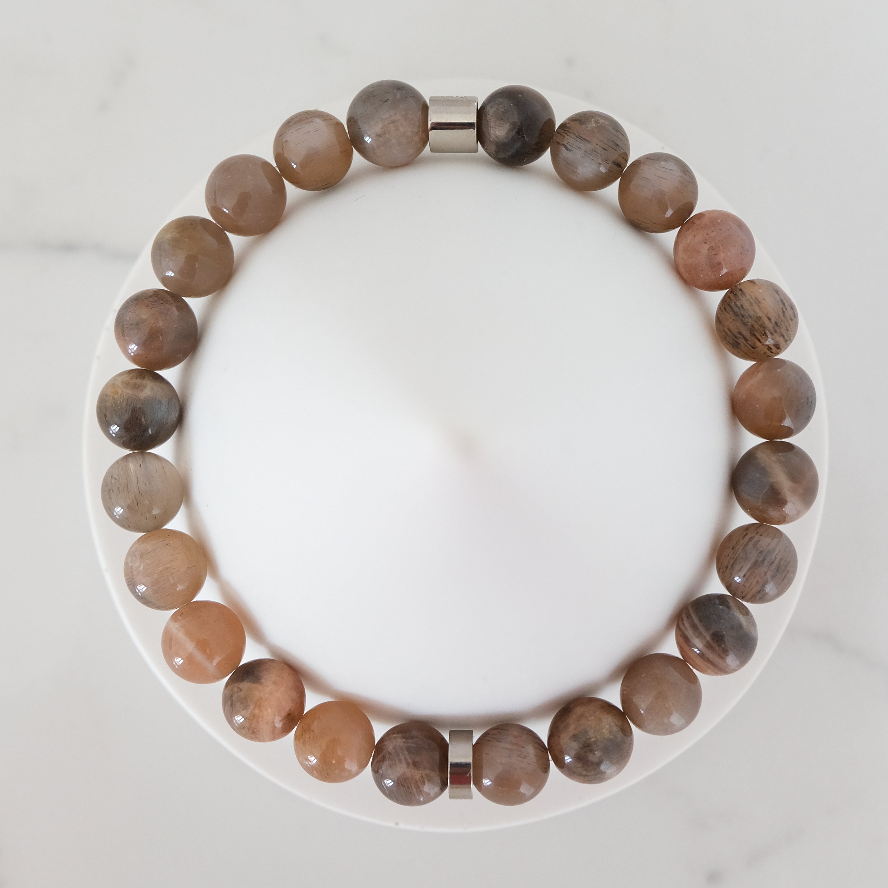 Black moonstone and sunstone gemstone bracelet with steel accessories from above