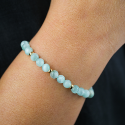 A model wearing a green moonstone 6mm bracelet with gold filled accessories