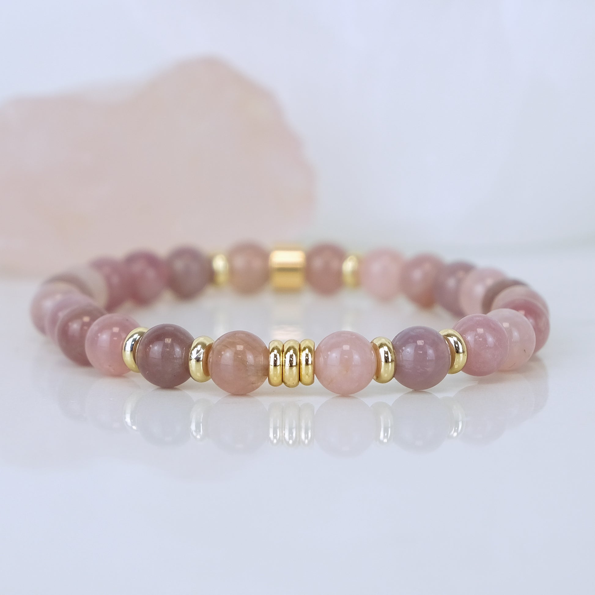 A lavender rose quartz gemstone bracelet in 6mm with gold plated accessories