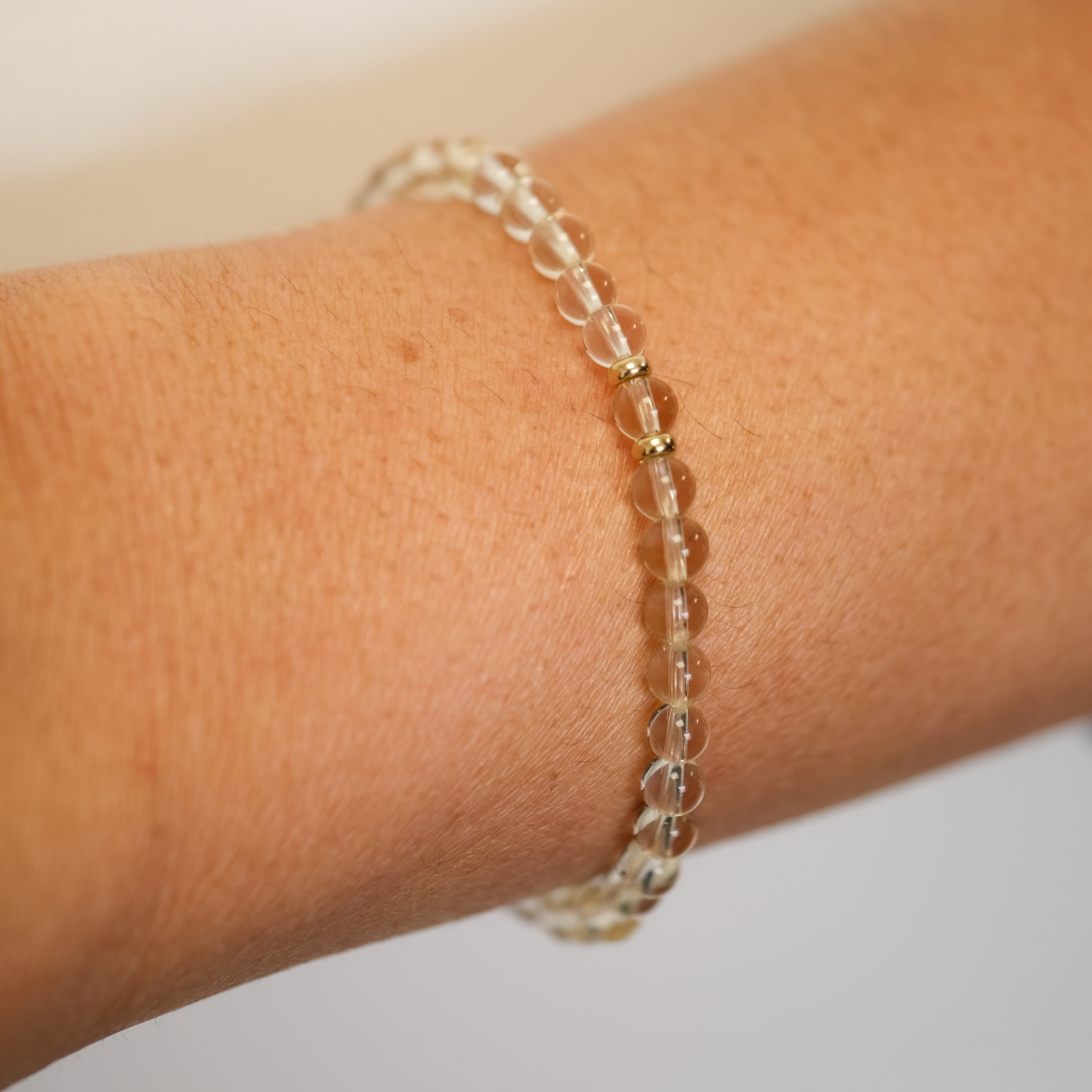 4mm citrine bracelet worn on a model's wrist