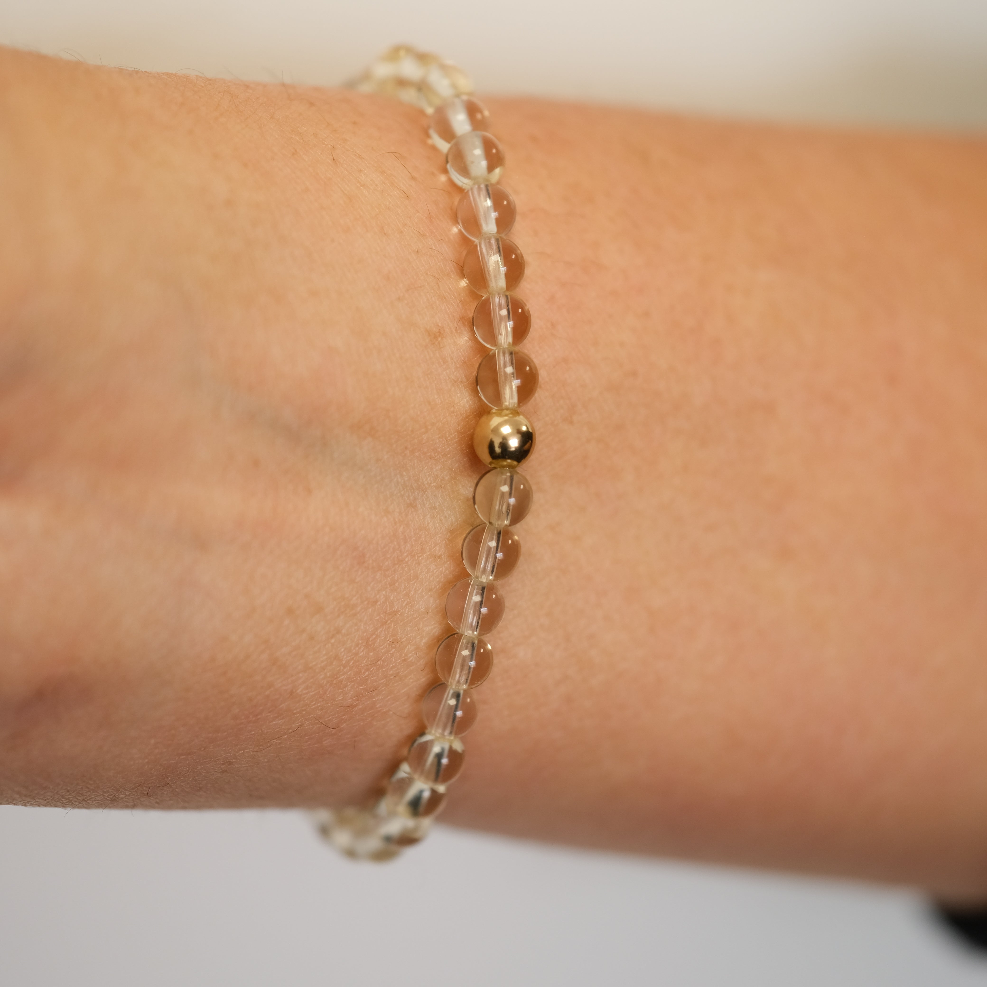 4mm citrine bracelet worn on a model's wrist from the back