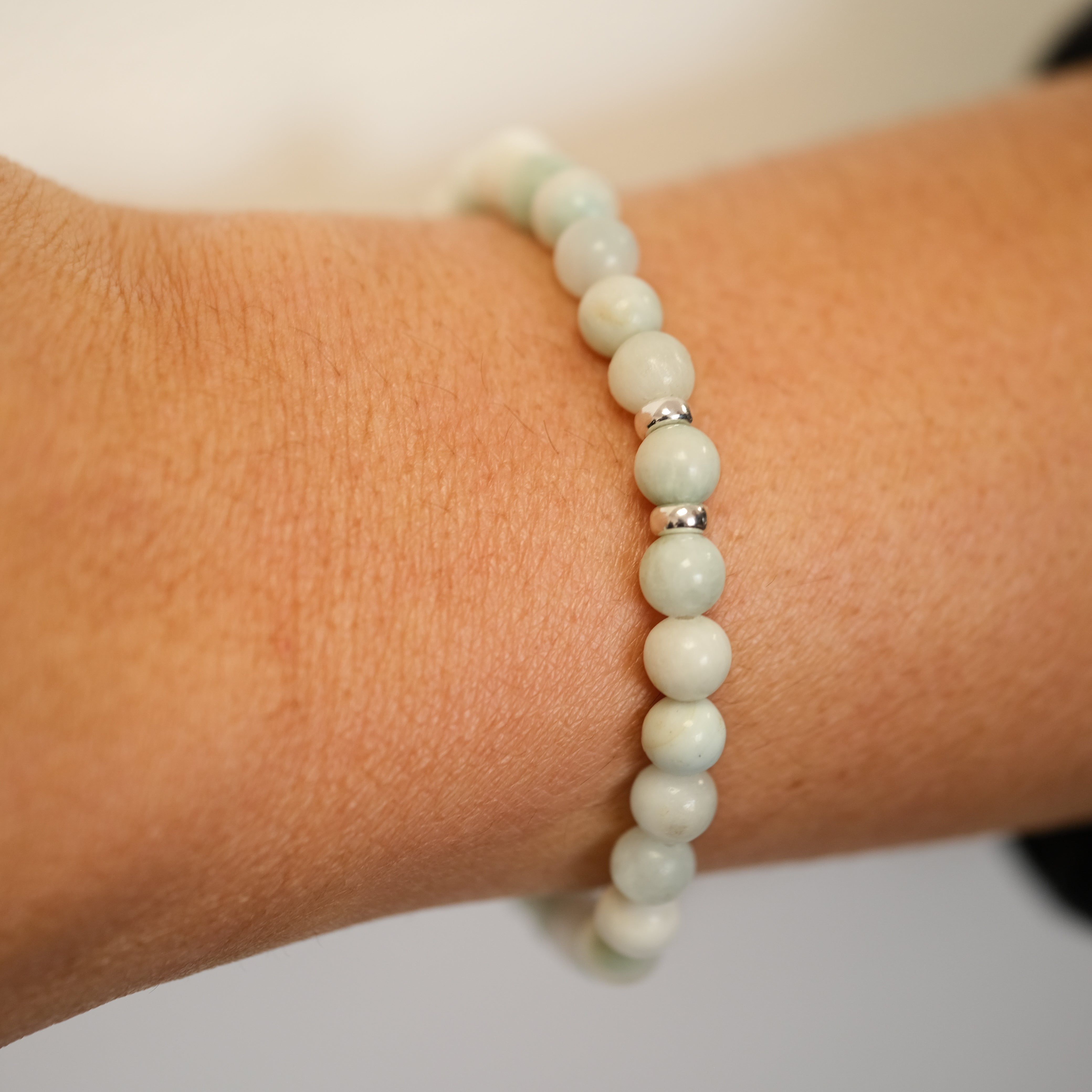 A Larimar gemstone bracelet worn on a model's wrist