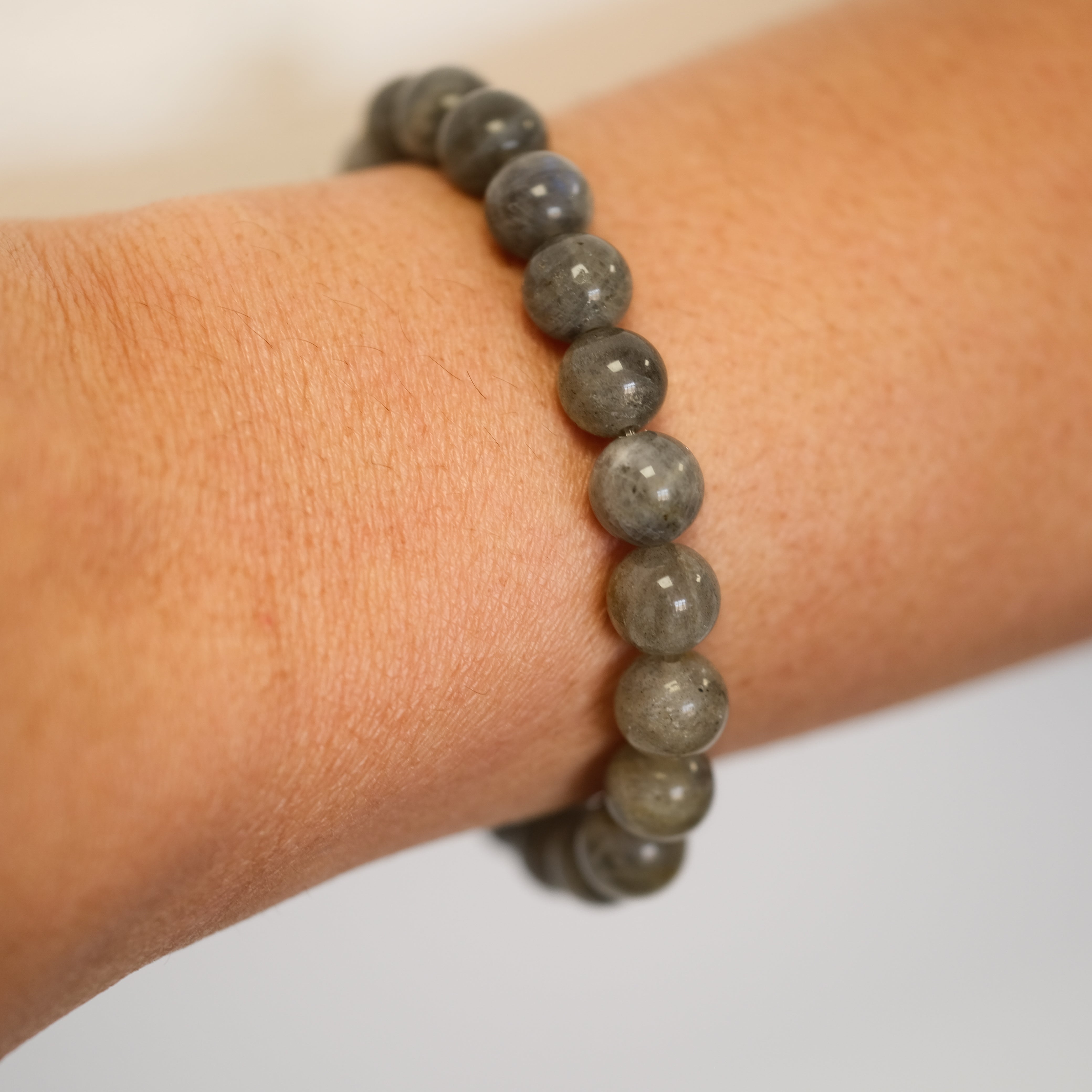 Labradorite gemstone bracelet worn on a model's wrist