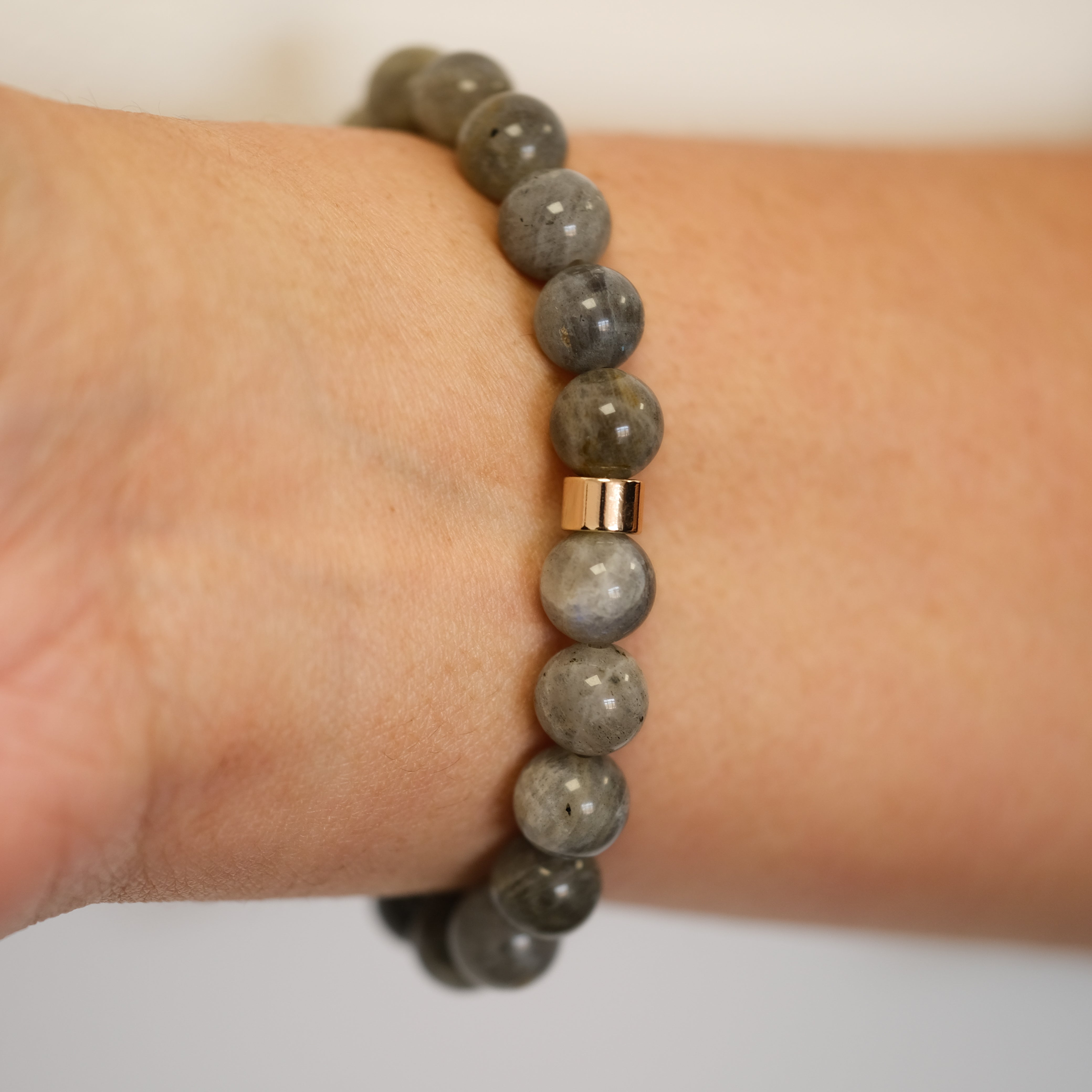 Labradorite gemstone bracelet worn on a model's wrist from the back