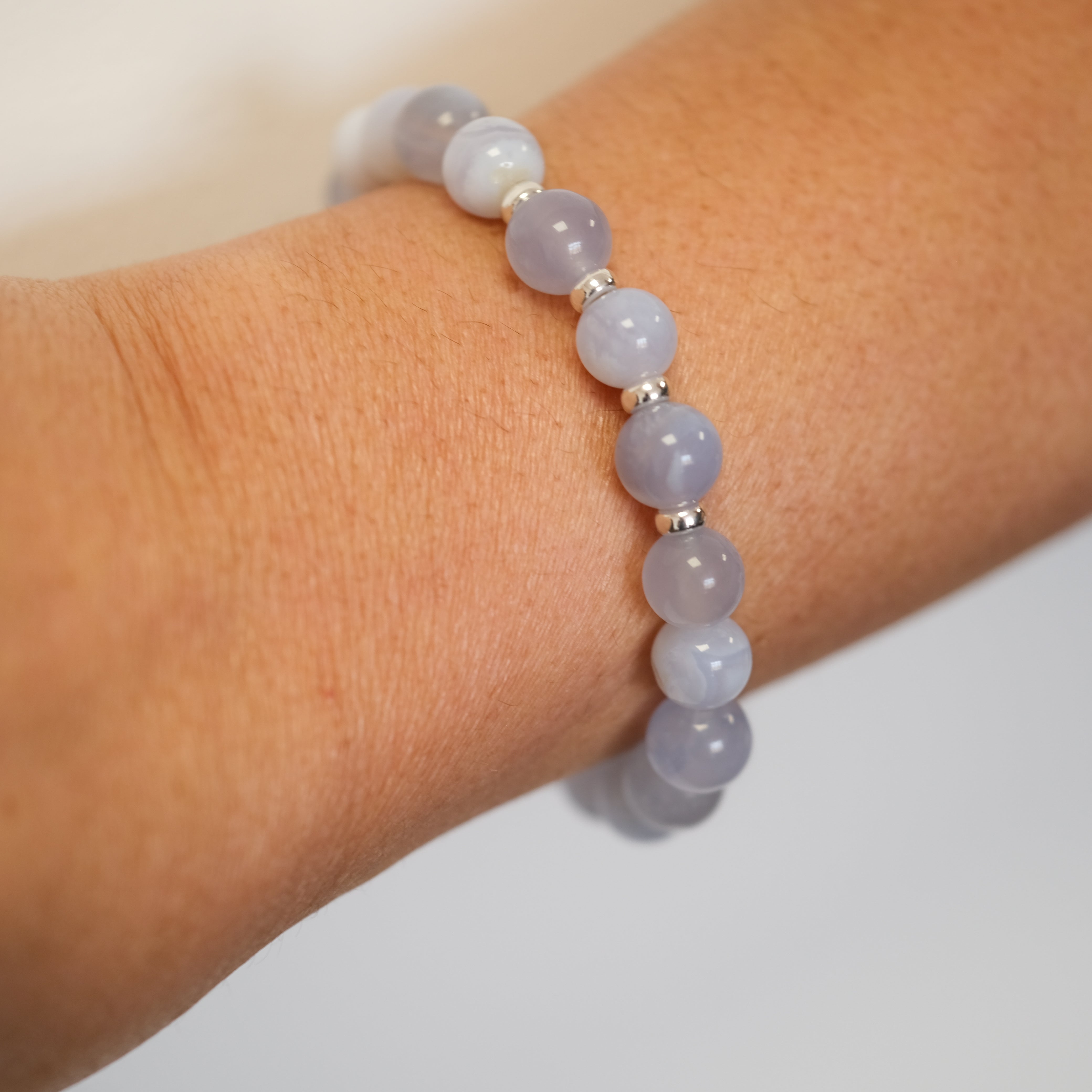 Blue Lace Agate gemstone bracelet in 8mm beads worn on a model's wrist