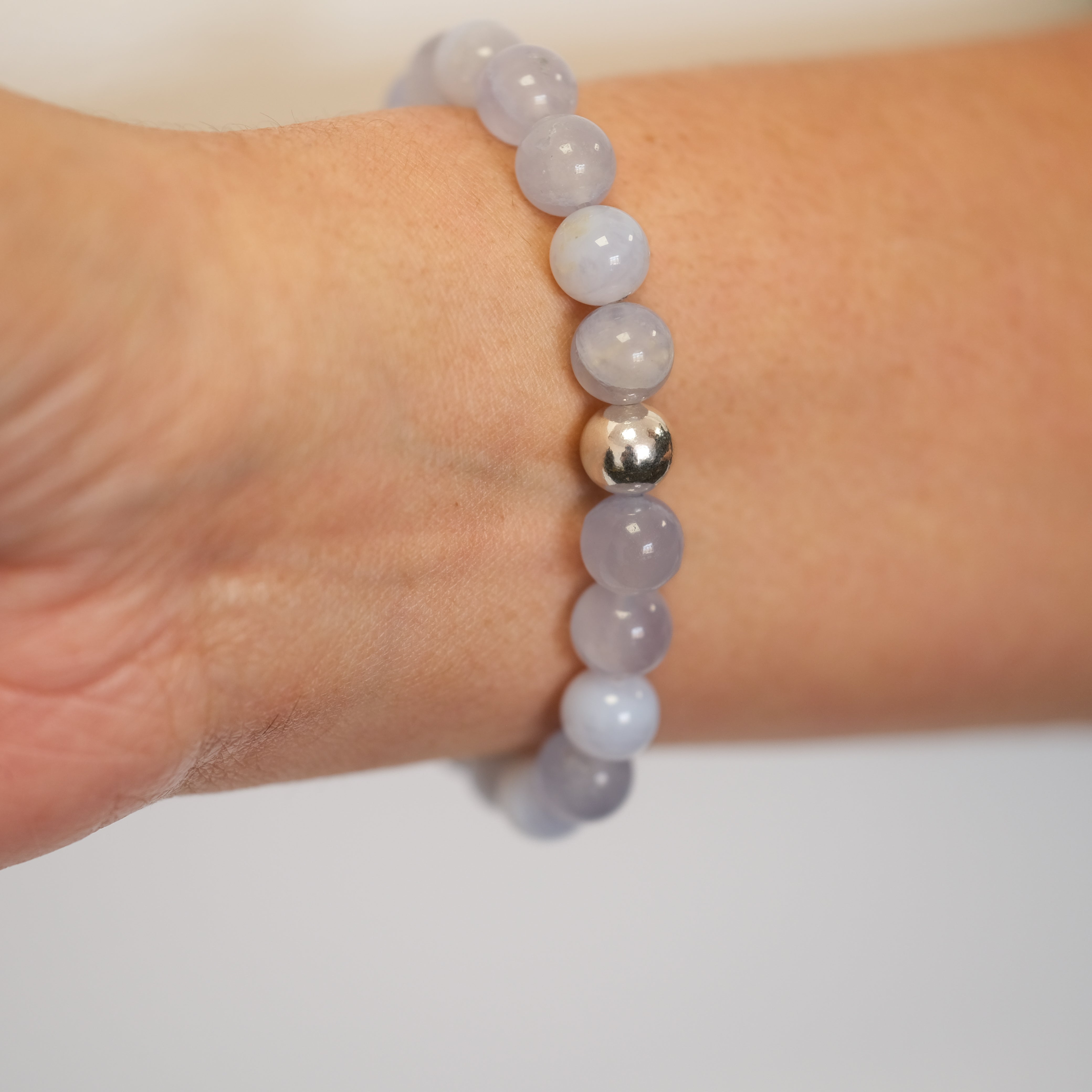 Blue Lace Agate gemstone bracelet in 8mm beads worn on a model's wrist from the back