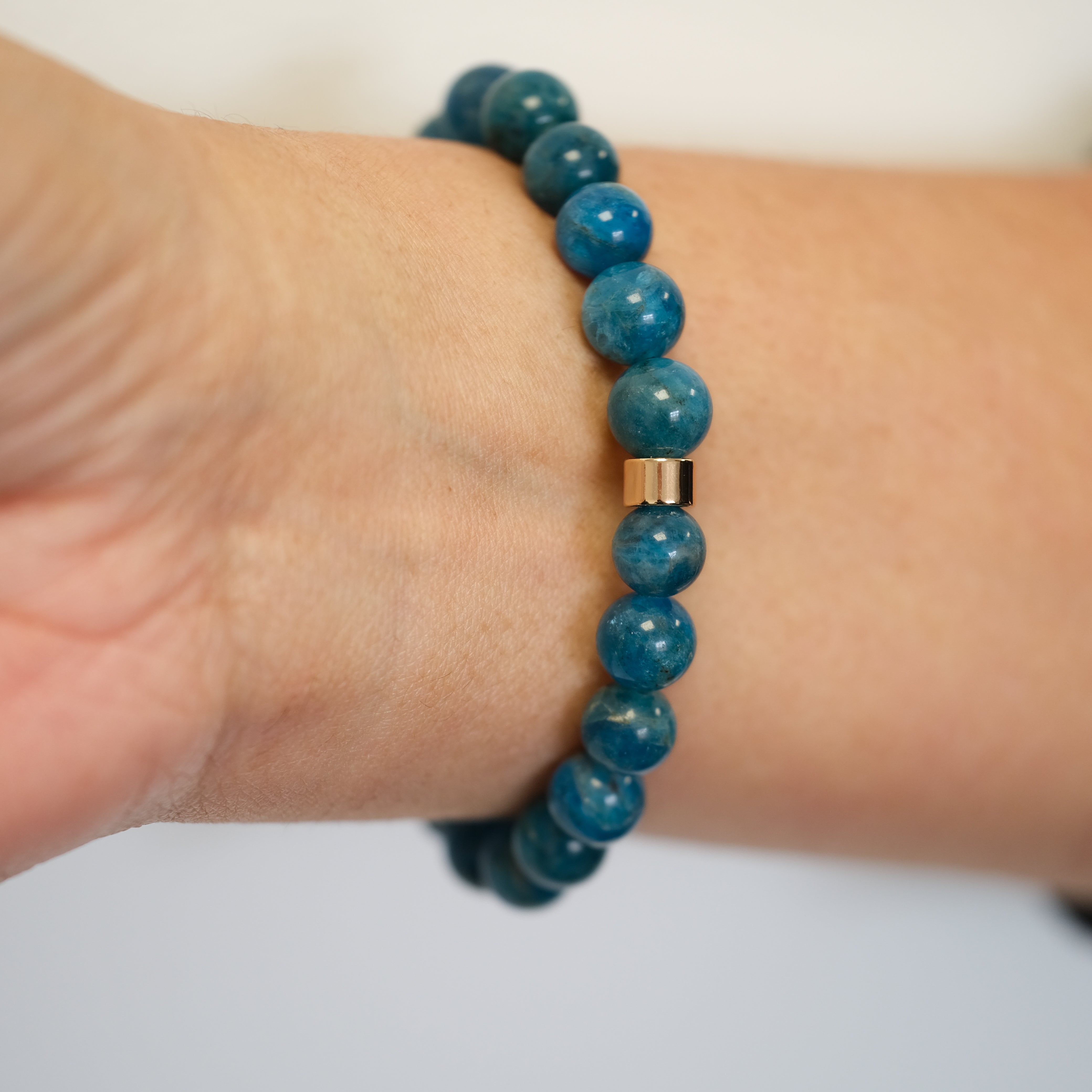 Apatite gemstone bracelet worn on a model's wrist