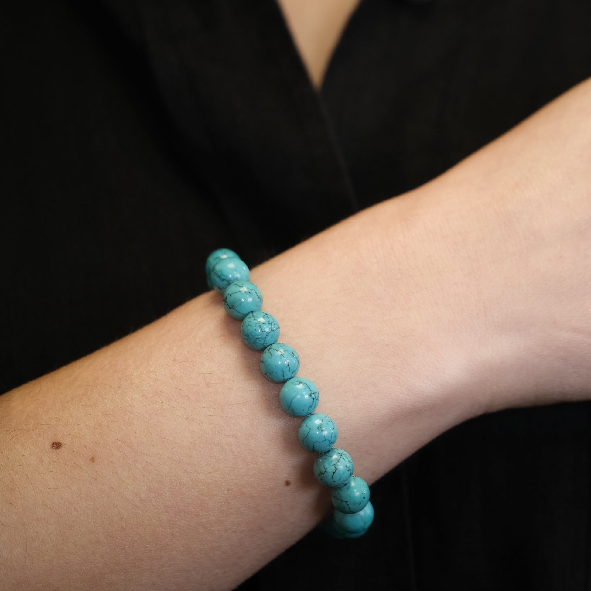 8mm turquoise gemstone bracelet pictured on female wrist