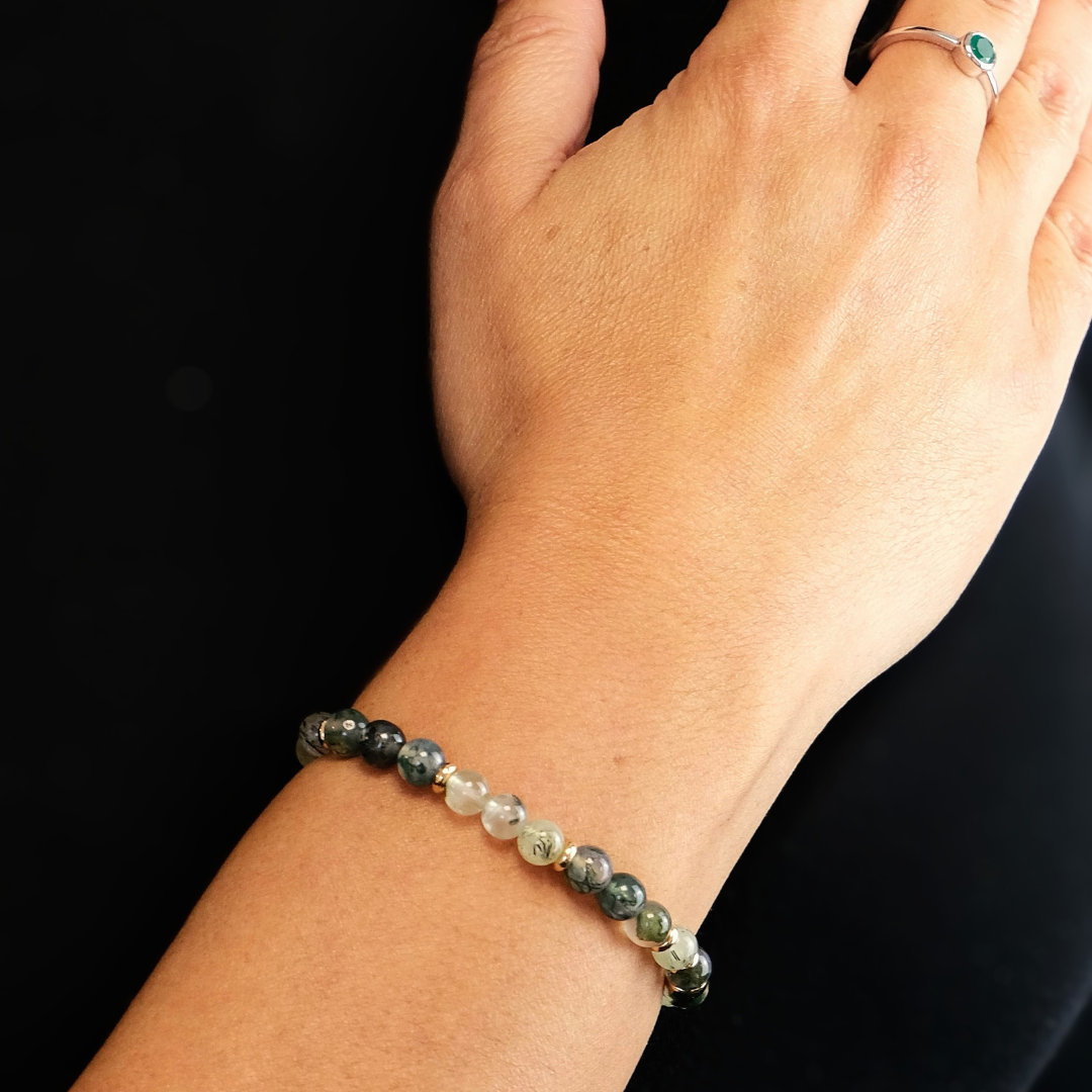 A model wearing a 6mm moss agate and prehnite bracelet
