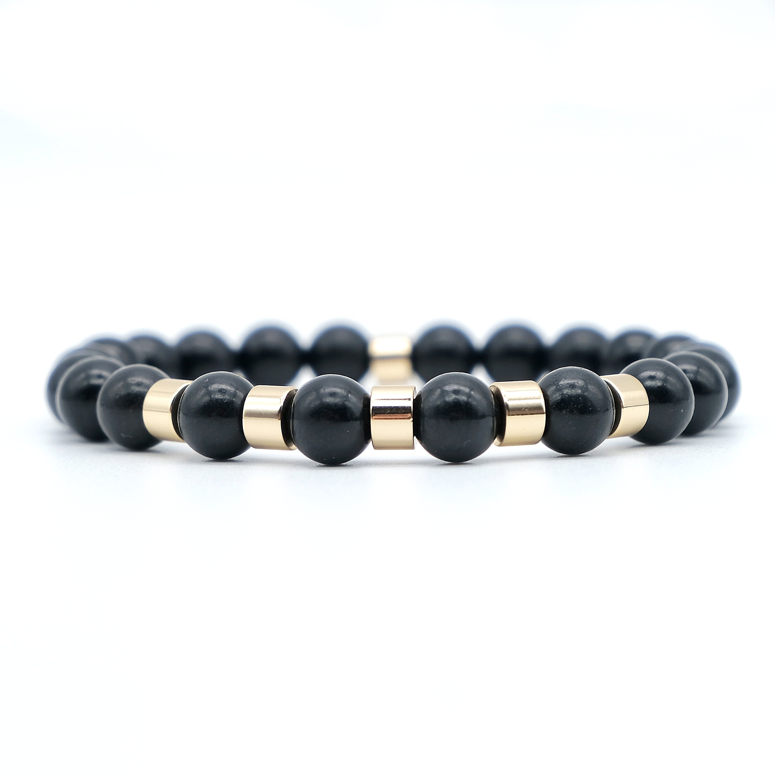 A shungite gemstone bracelet with gold accessories