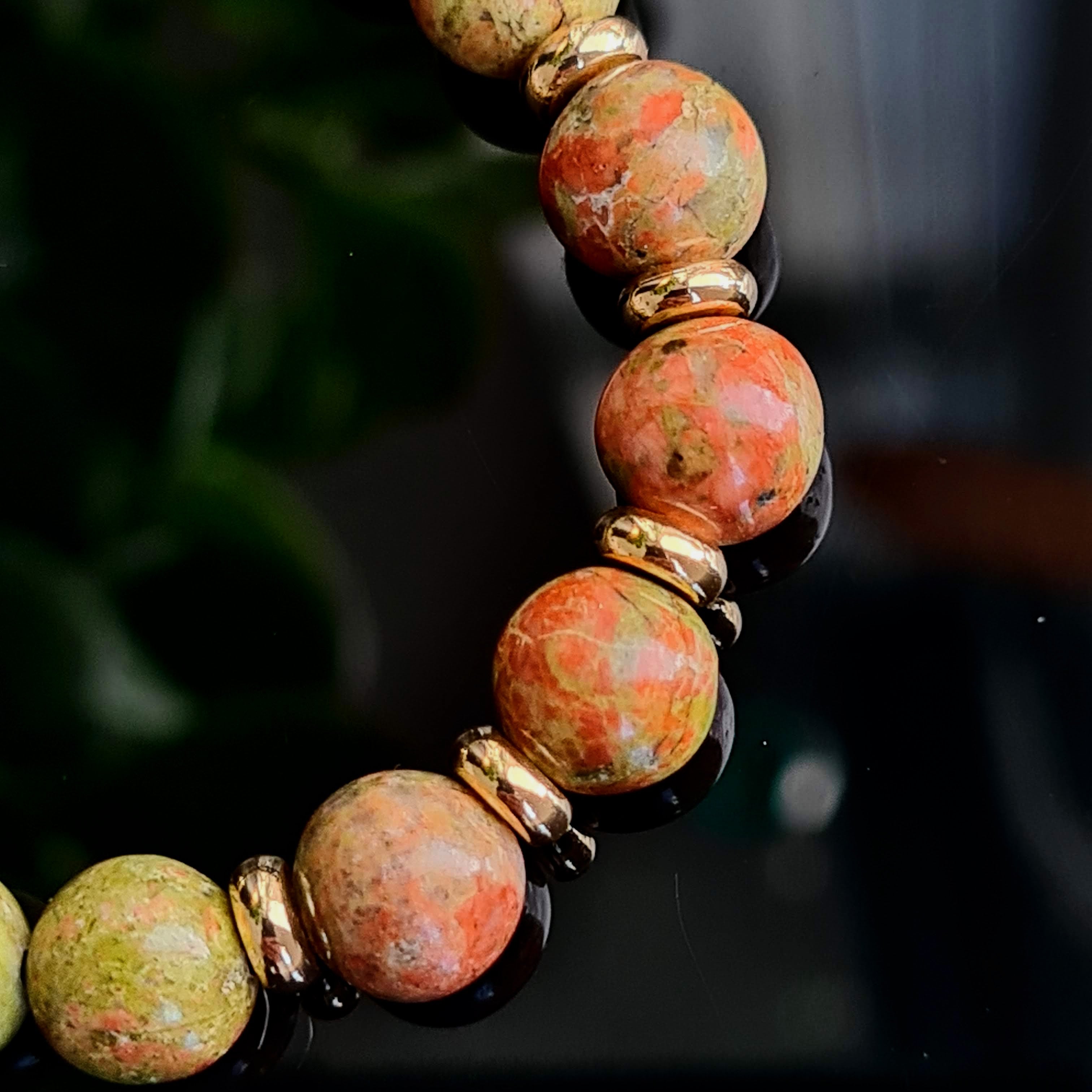 Close up of 8mm Unakite Stones with 18ct gold plated accessories