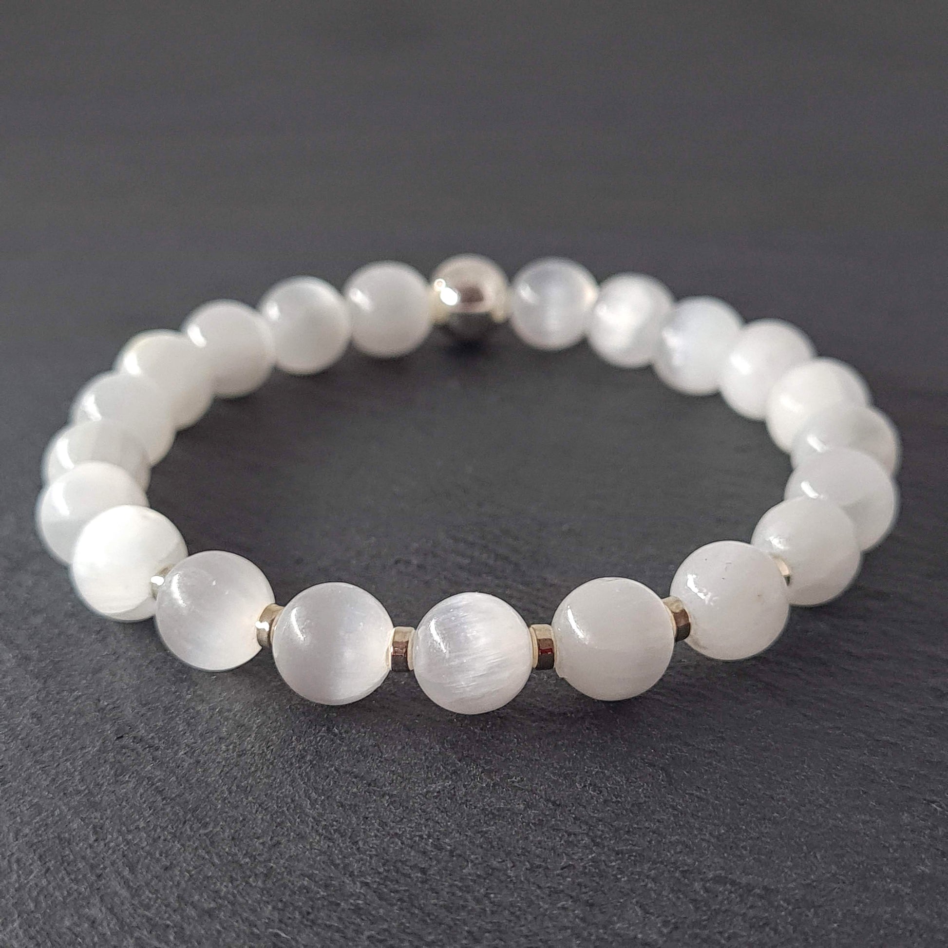 Samayla Jewellery's Selenite energy gemstone bracelet with silver accents, photographed on a dark grey slate.