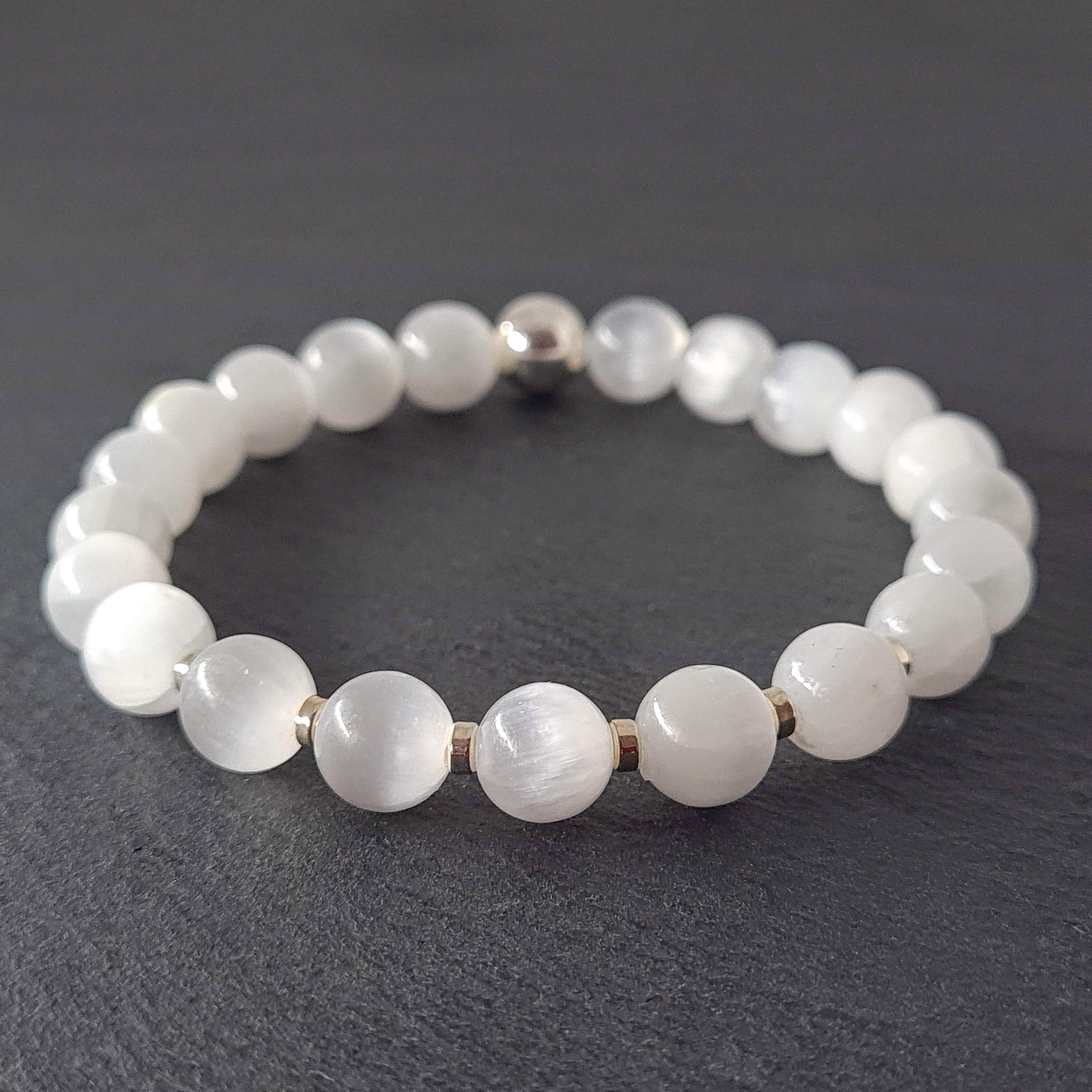 Samayla Jewellery's Selenite energy gemstone bracelet with silver accents, photographed on a dark grey slate.