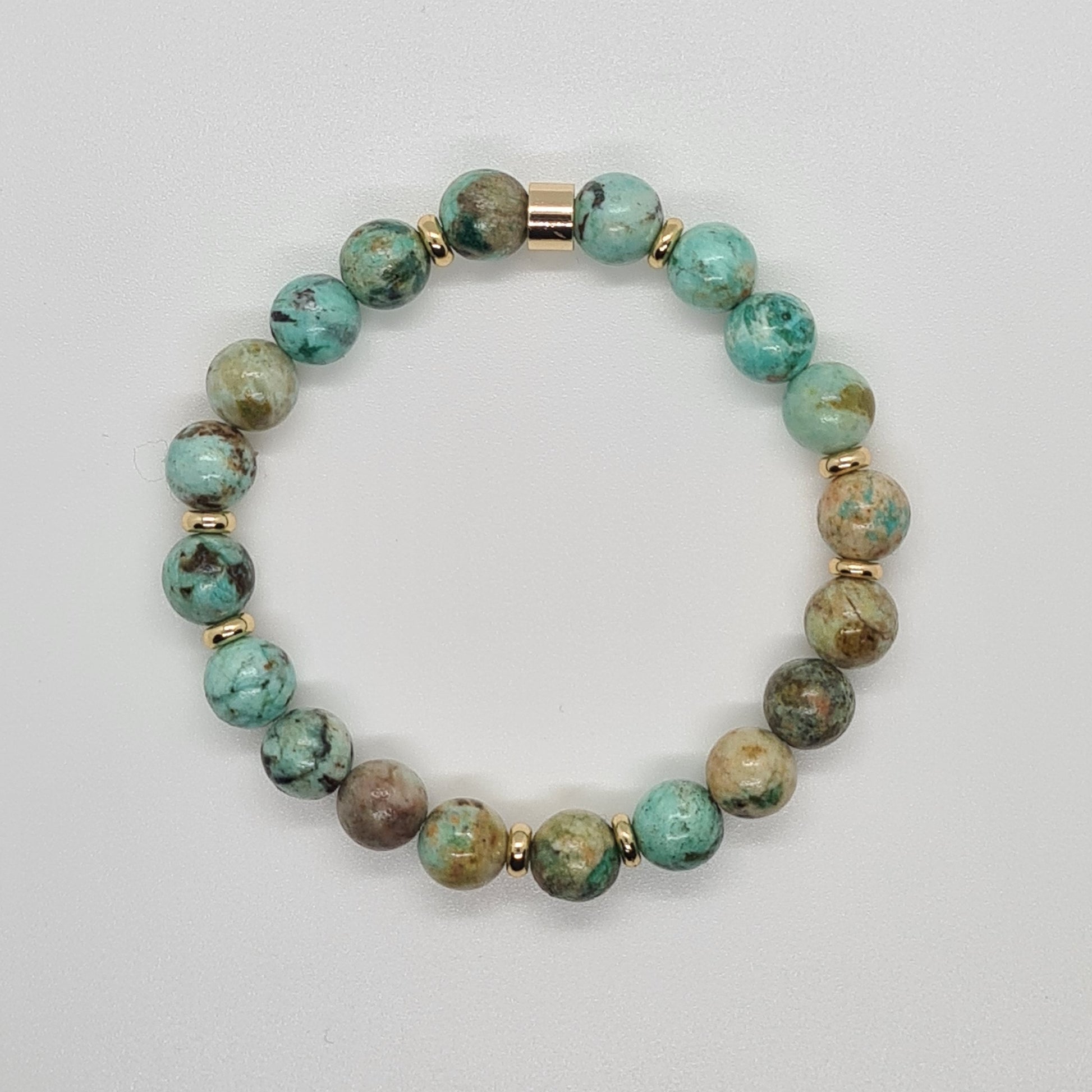 A chrysocolla gemstone bracelet in 8mm beads with gold accessories from above
