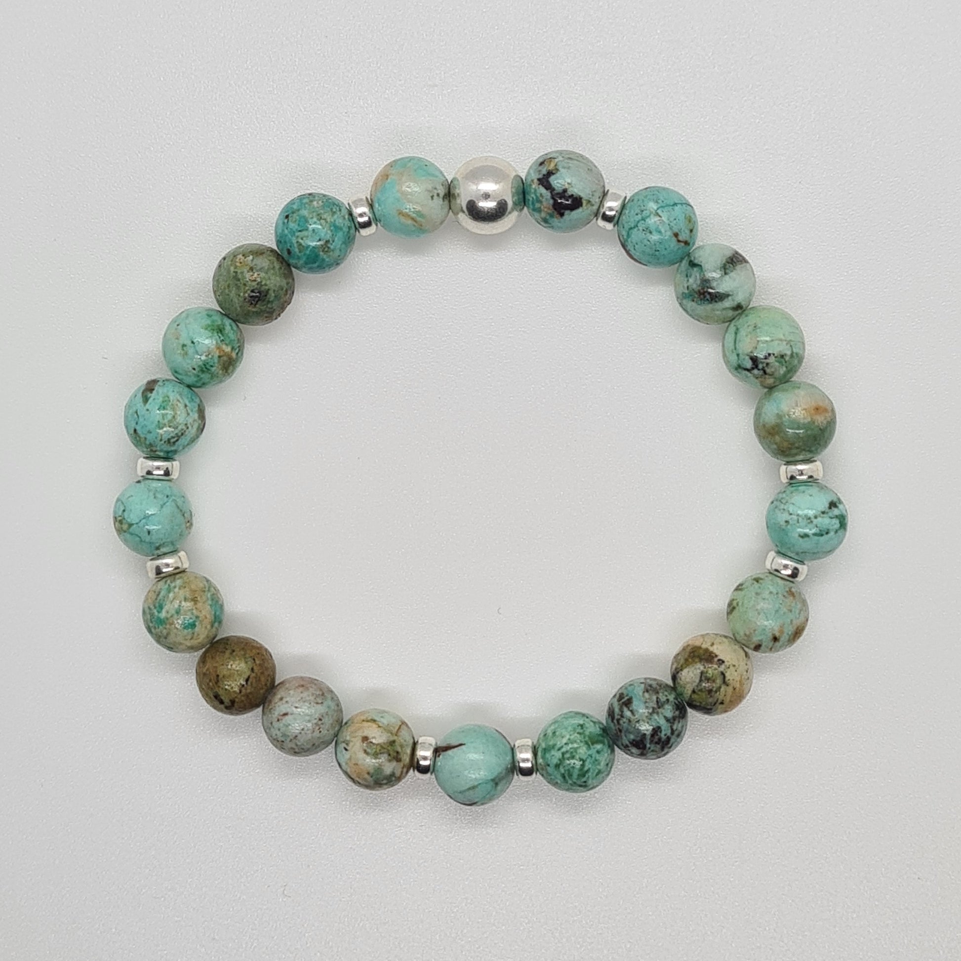 A chrysocolla gemstone bracelet in 8mm beads with silver accessories from above