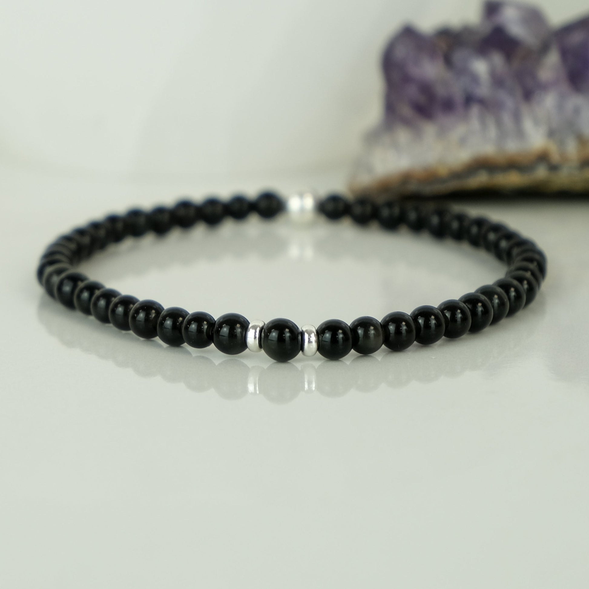 A Black obsidian gemstone bracelet in 4mm beads with silver accessories