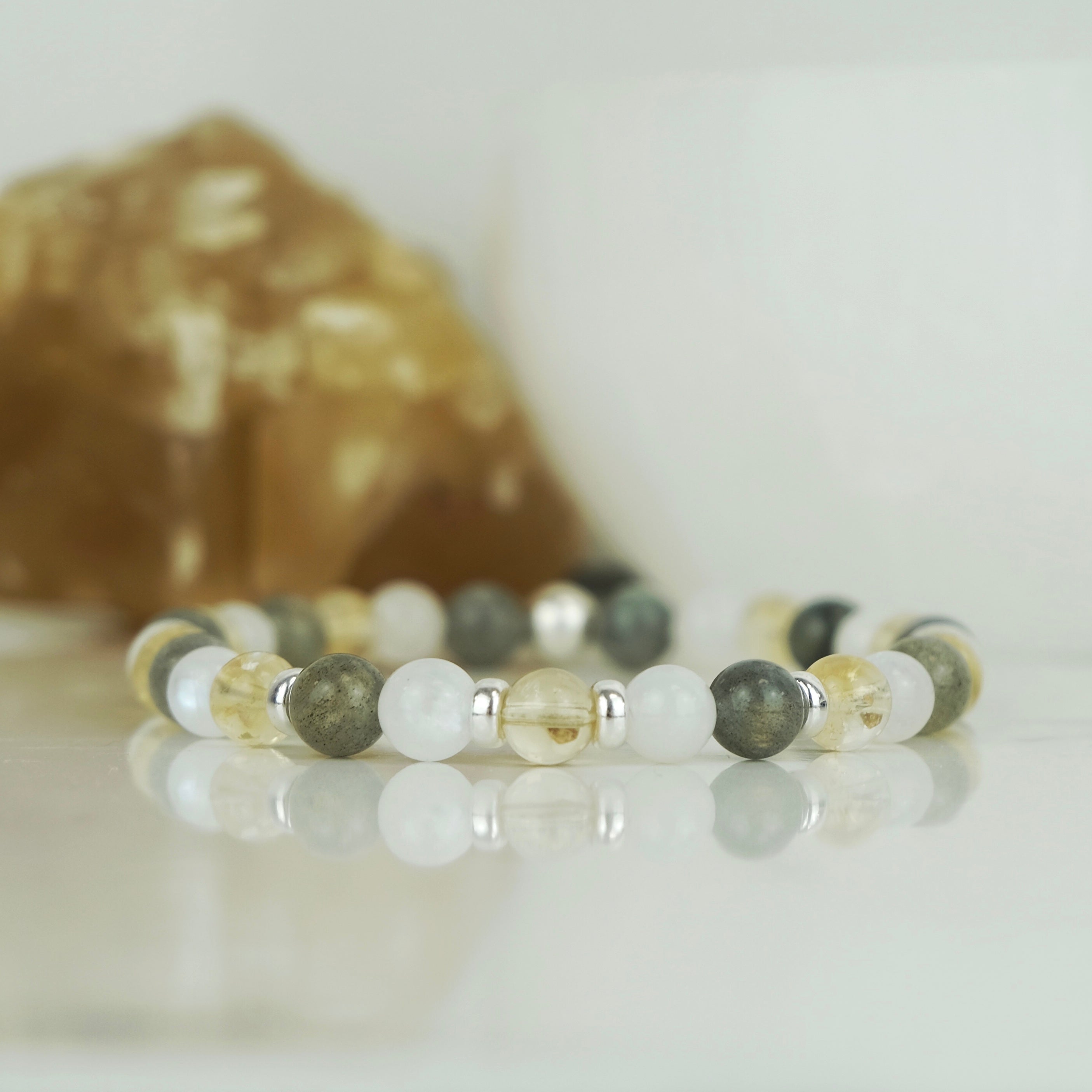 A citrine, labradorite and moonstone gemstone bracelet in 6mm beads with silver accessories