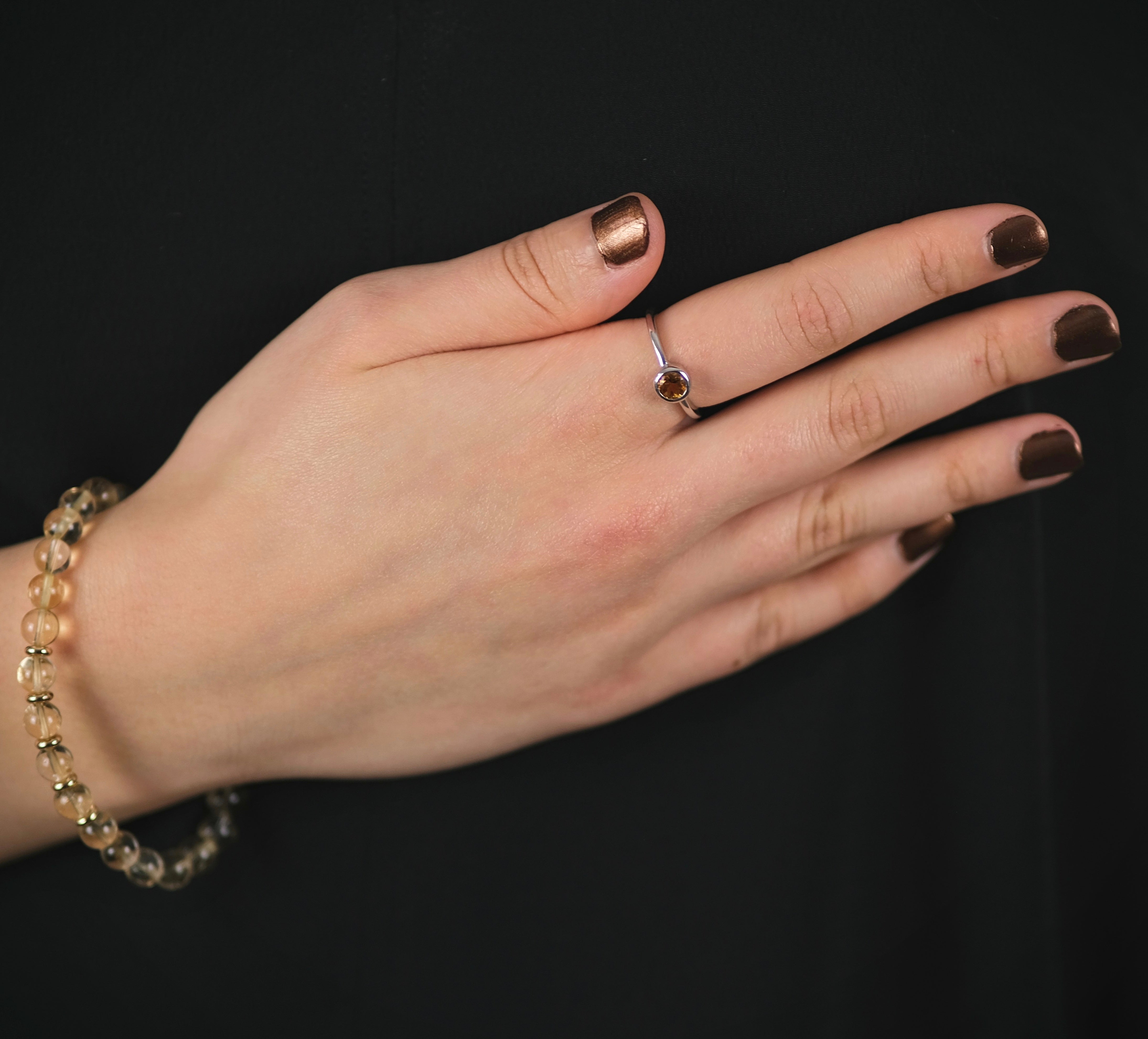 A model wearng a Citrine minimal circle gemstone ring in silver