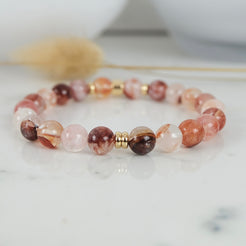 Red phantom quartz bracelet with gold accessories