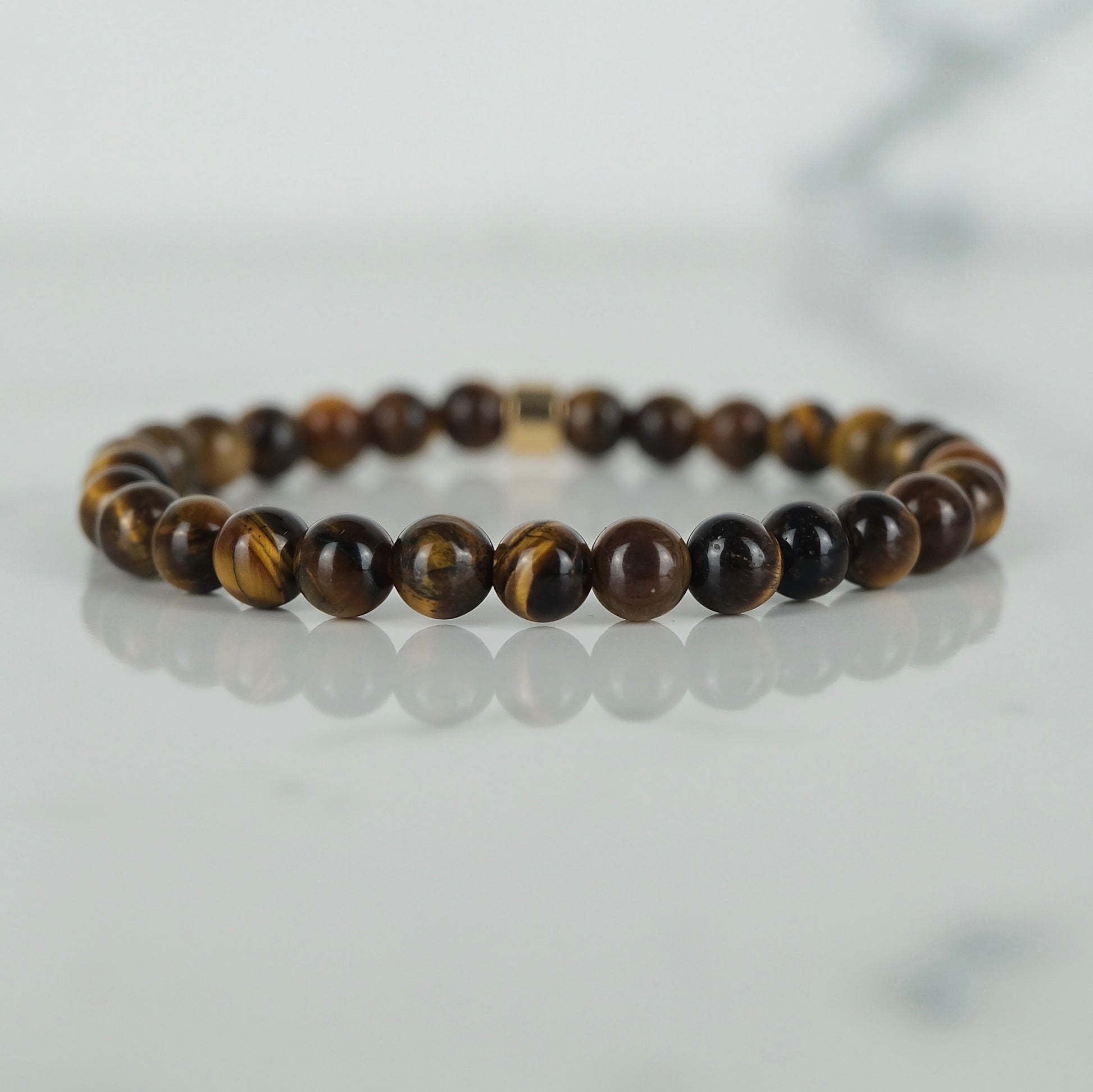 A tiger eye gemstone bracelet in 6mm beads with gold accessory
