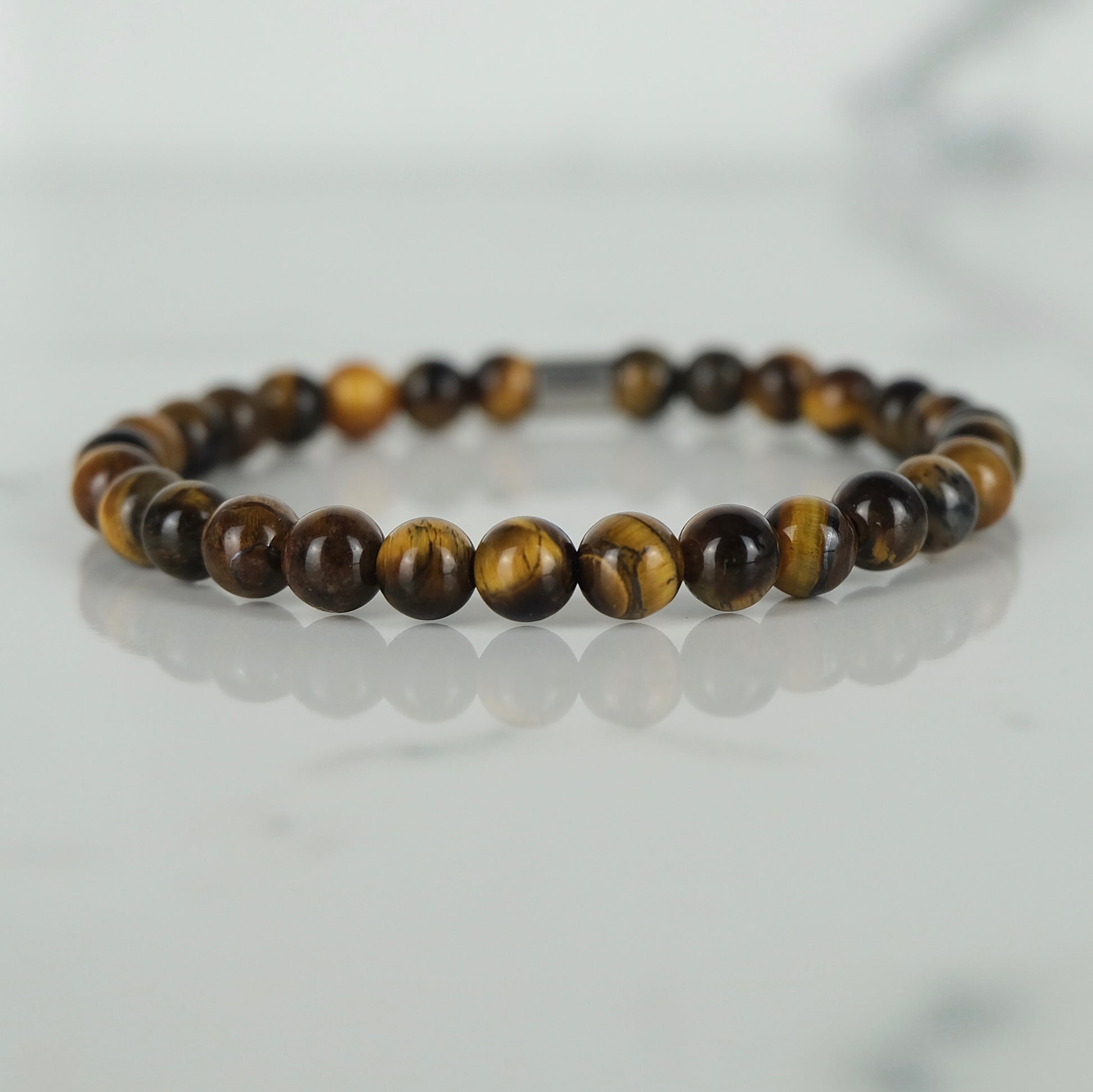 A tiger eye gemstone bracelet in 6mm beads with steel accessory