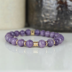 A lepidolite gemstone bracelet with gold accessories