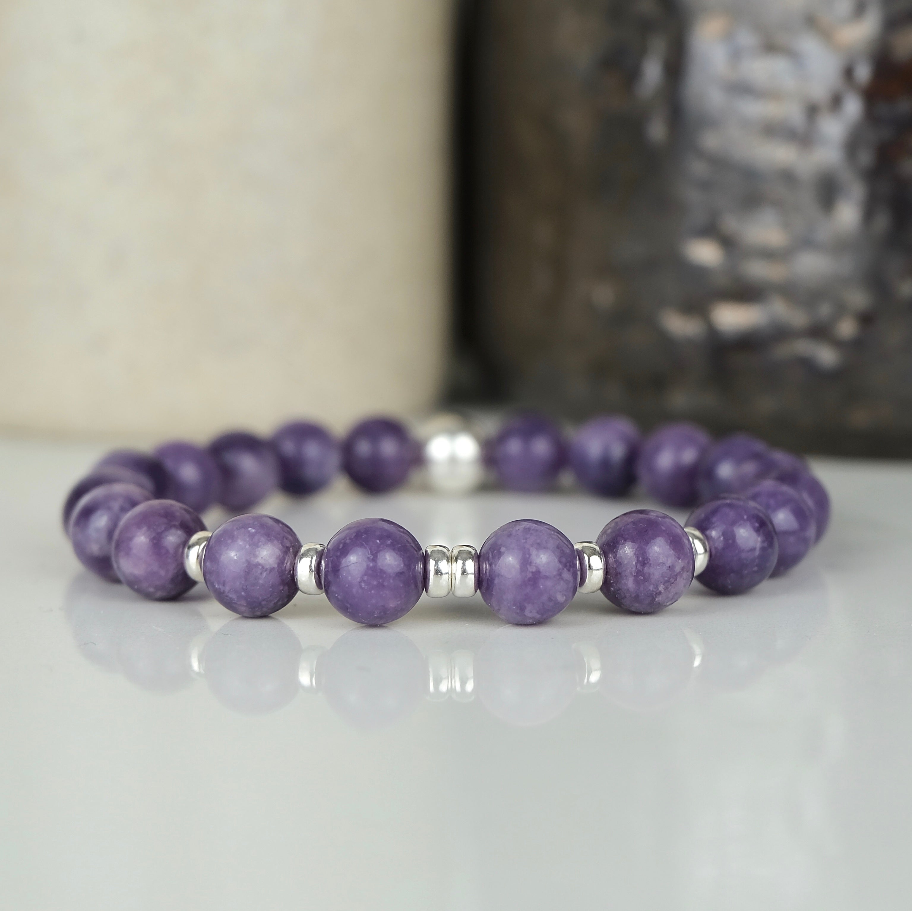 A lepidolite gemstone bracelet with silver accessories