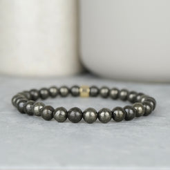 A pyrite gemstone bracelet in 6mm beads with gold accessory