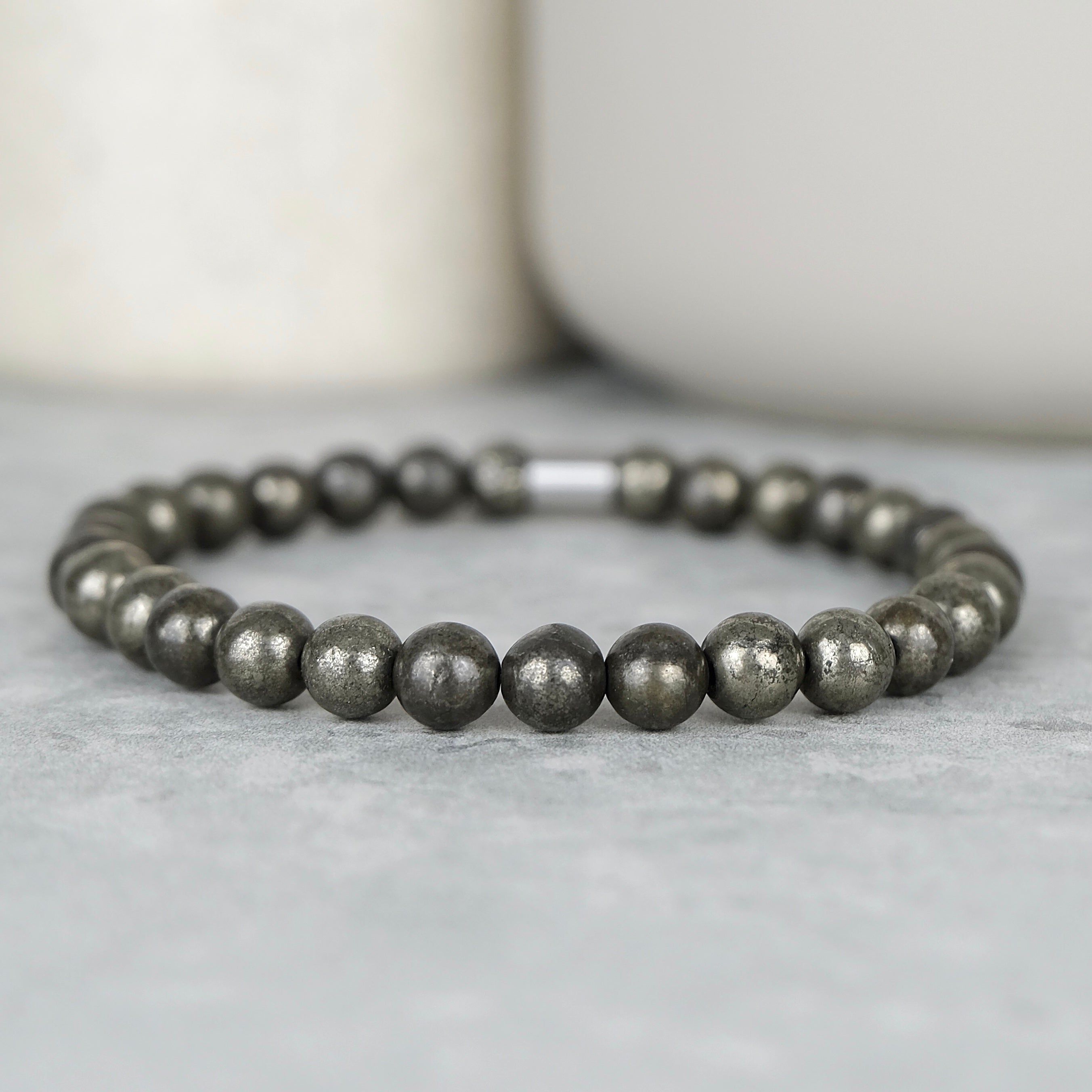 A pyrite gemstone bracelet in 6mm beads with steel accessory