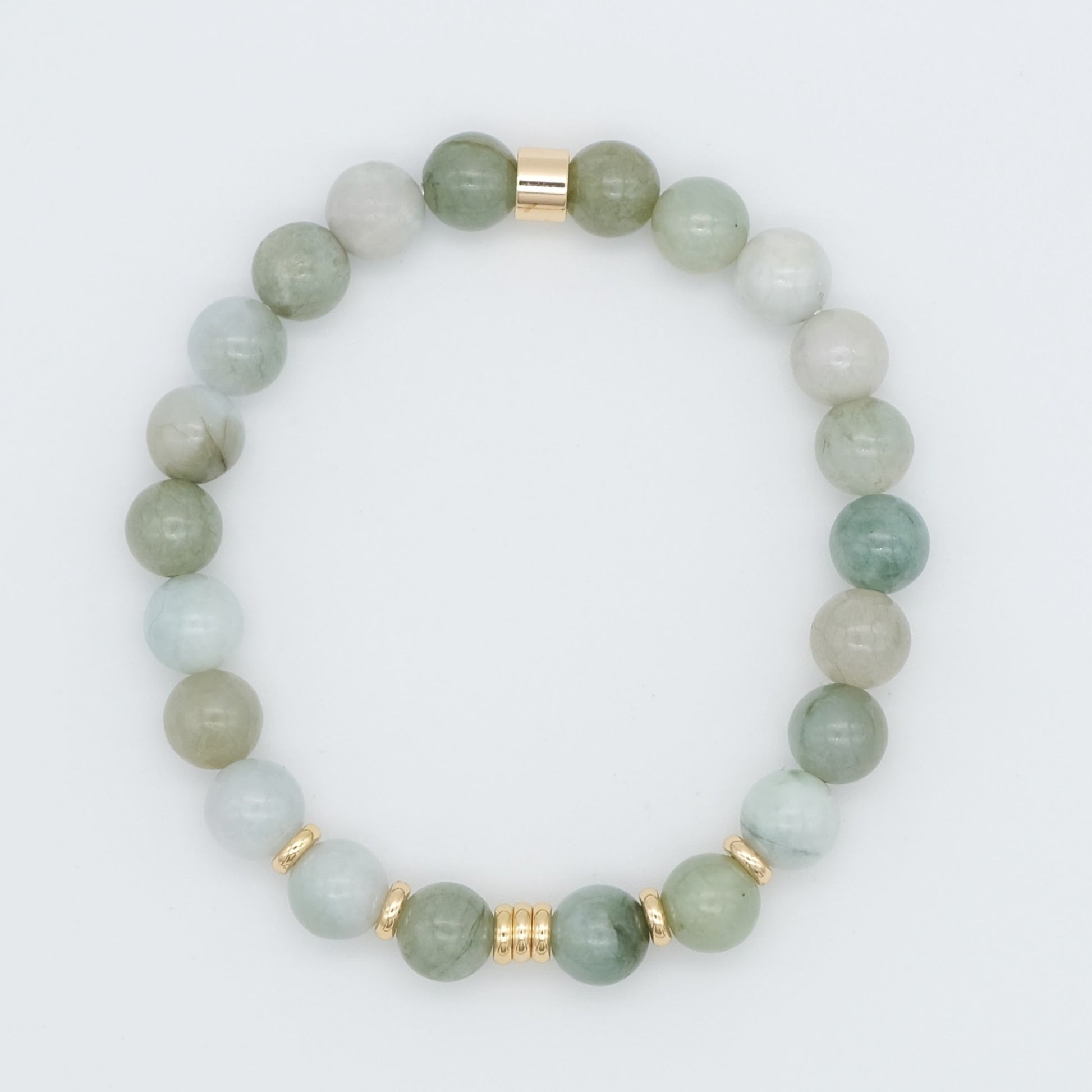 A jade gemstone bracelet with gold plated accessories from above