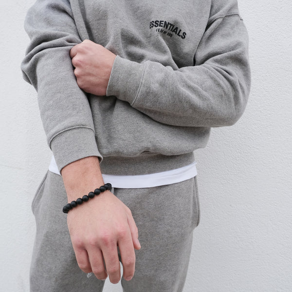 Matte onyx gemstone bracelet worn on a model's wrist