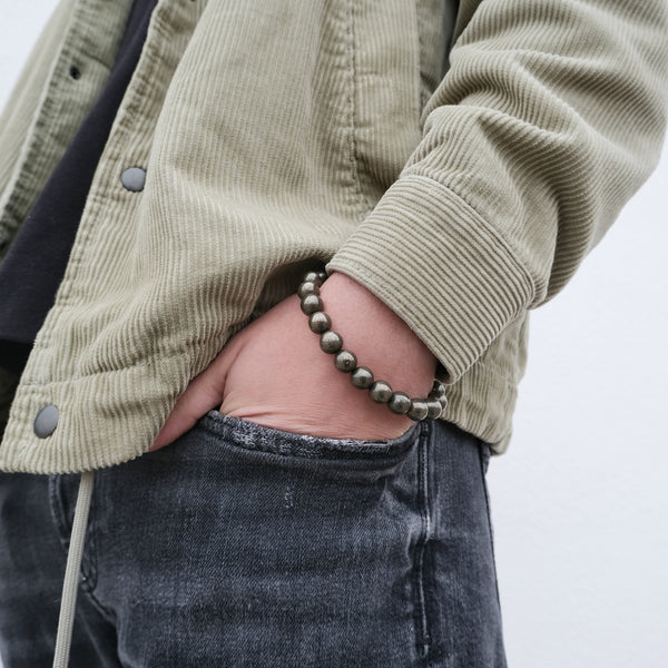Pyrite gemstone bracelet worn on a model's wrist