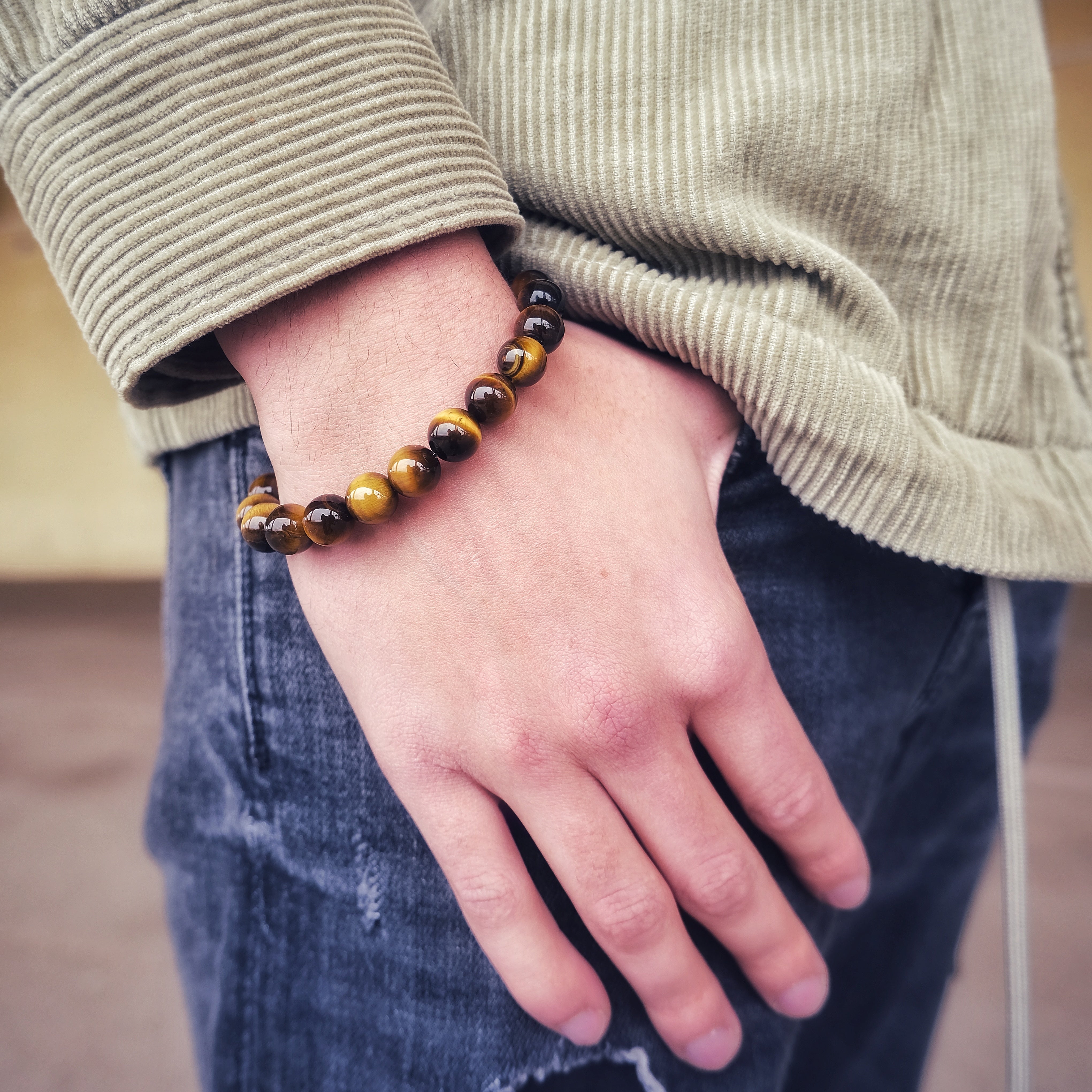 Tiger Eye gemstone bracelet  in 10mm beads worn on a model's wrist