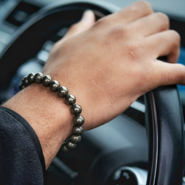Pyrite gemstone bracelet worn on a model's wrist