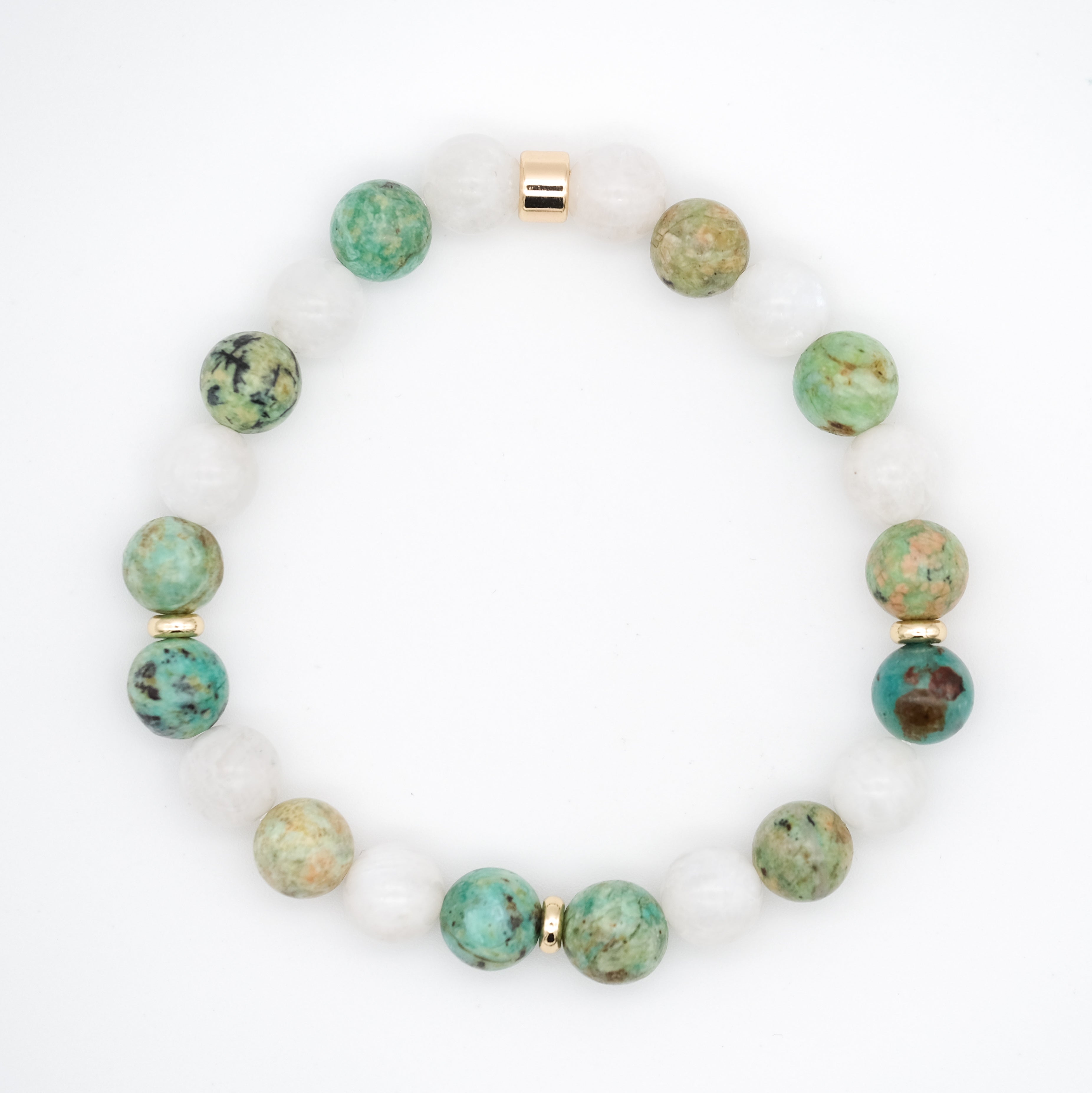 A moonstone and chrysocolla gemstone bracelet with gold accessories from above