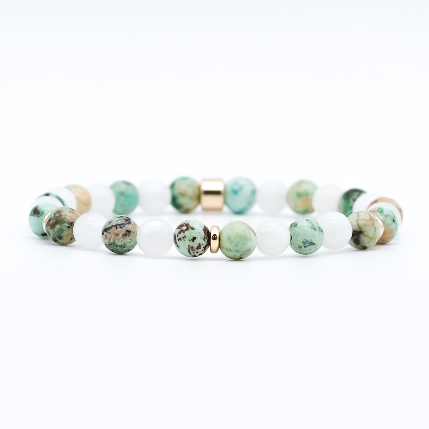 A moonstone and chrysocolla gemstone bracelet in 6mm beads with gold accessories