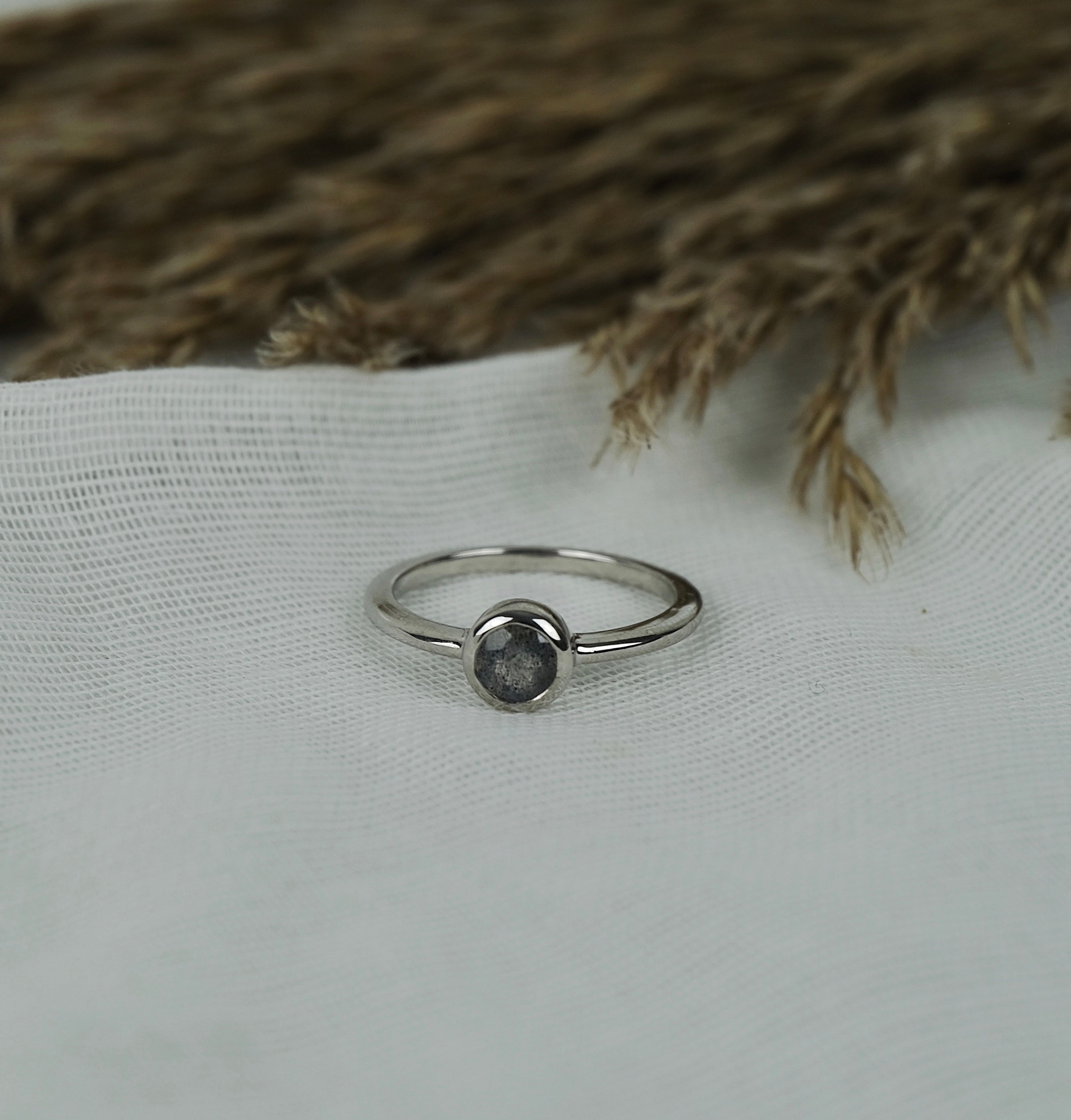 A model wearing Labradorite minimal circle gemstone ring in silver