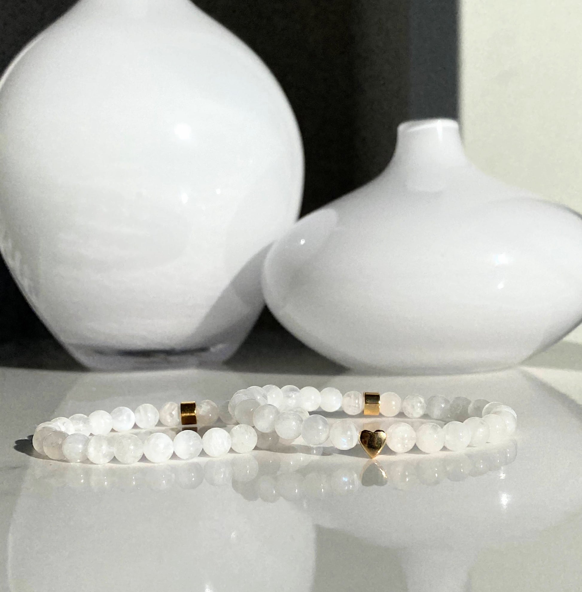 Moonstone 6mm bracelets one with an additional 18ct gold plated heart