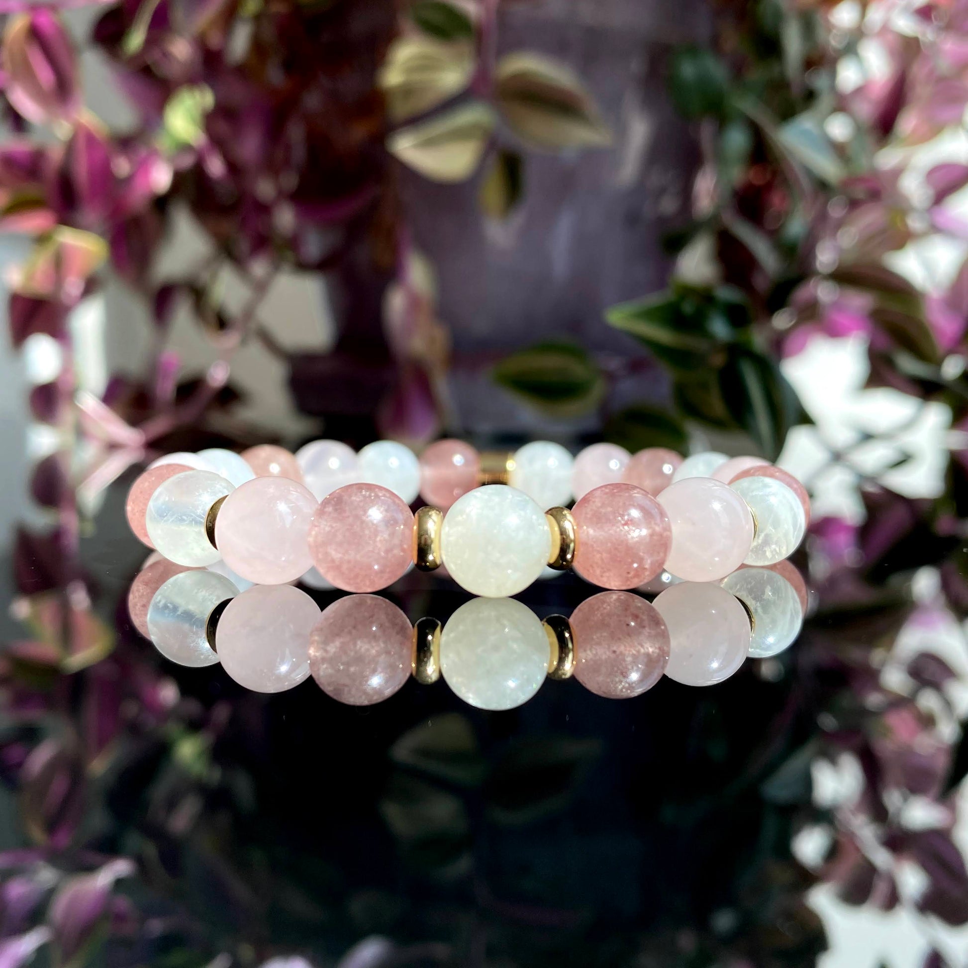 A moonstone, strawberry quartz and rose quartz gemstone bracelet with gold accessories