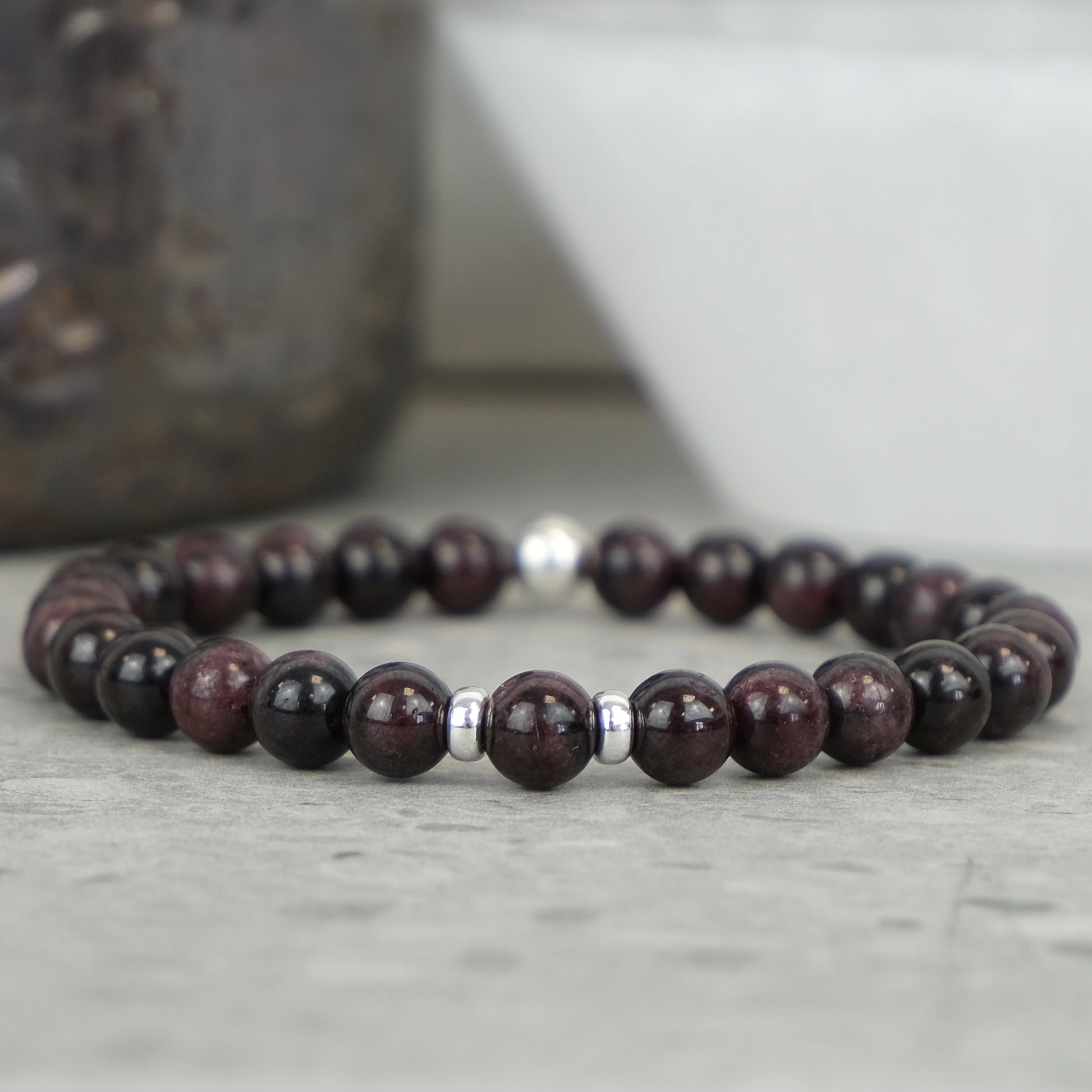 A garnet gemstone bracelet in 6mm beads with silver accessories