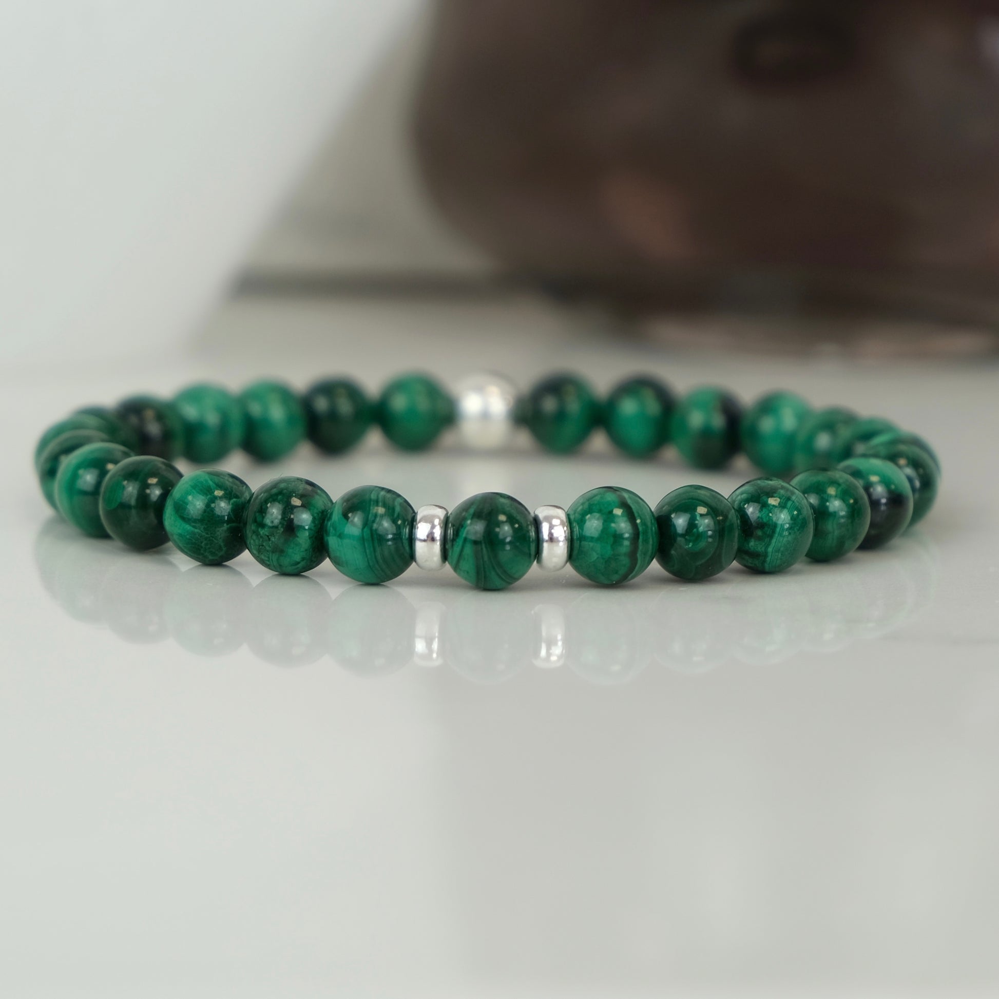 A malachite gemstone bracelet with silver accessories