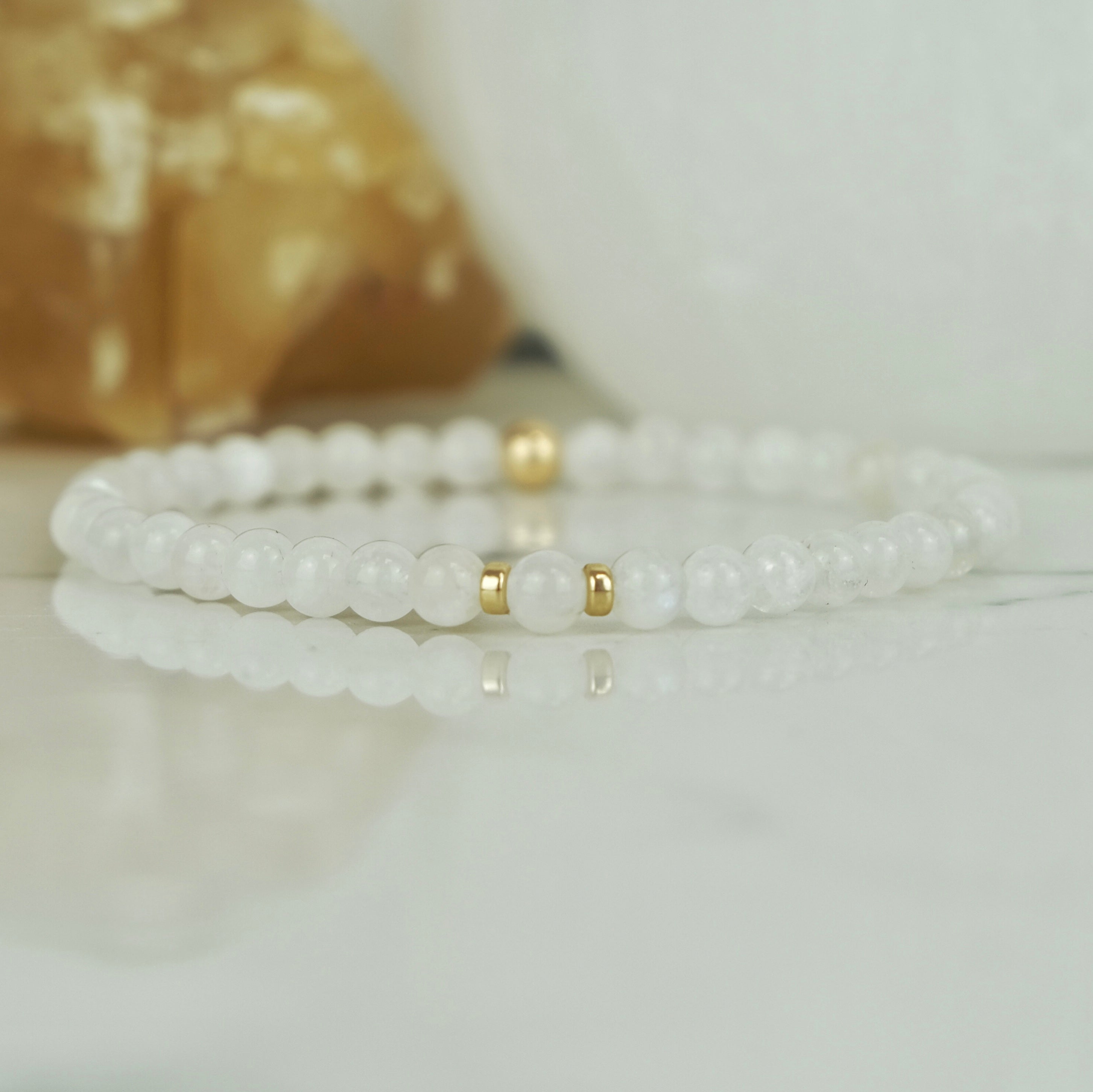 A moonstone gemstone bracelet in 4mm beads with gold filled accessories